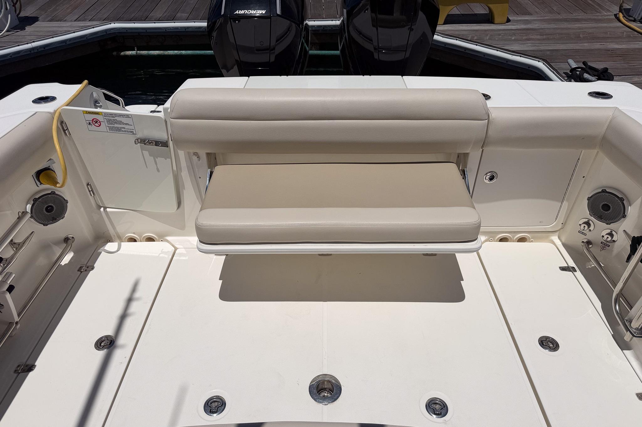 2021 Boston Whaler 330 Outrage boat interior with cushioned seating and deck features.