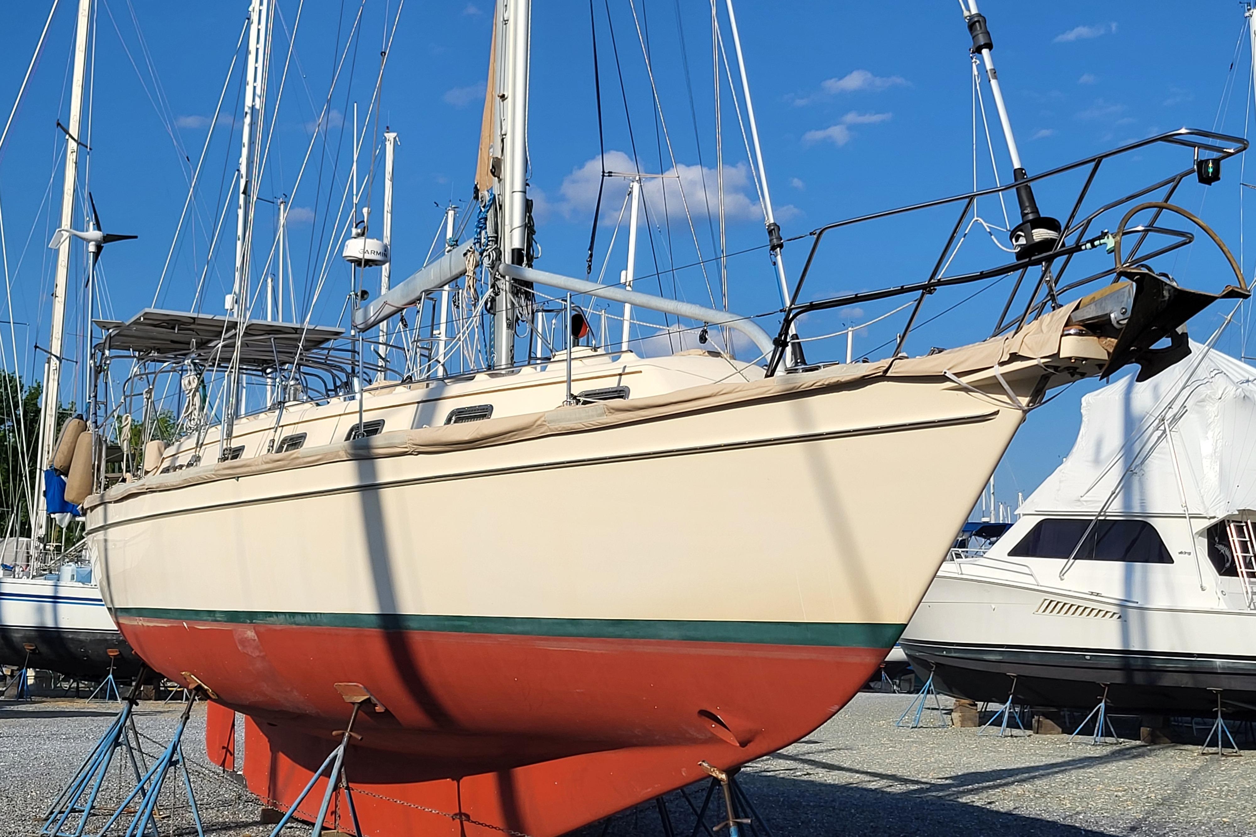 Island Packet 420 sailboat from 2000 on stands, with clear blue sky background.