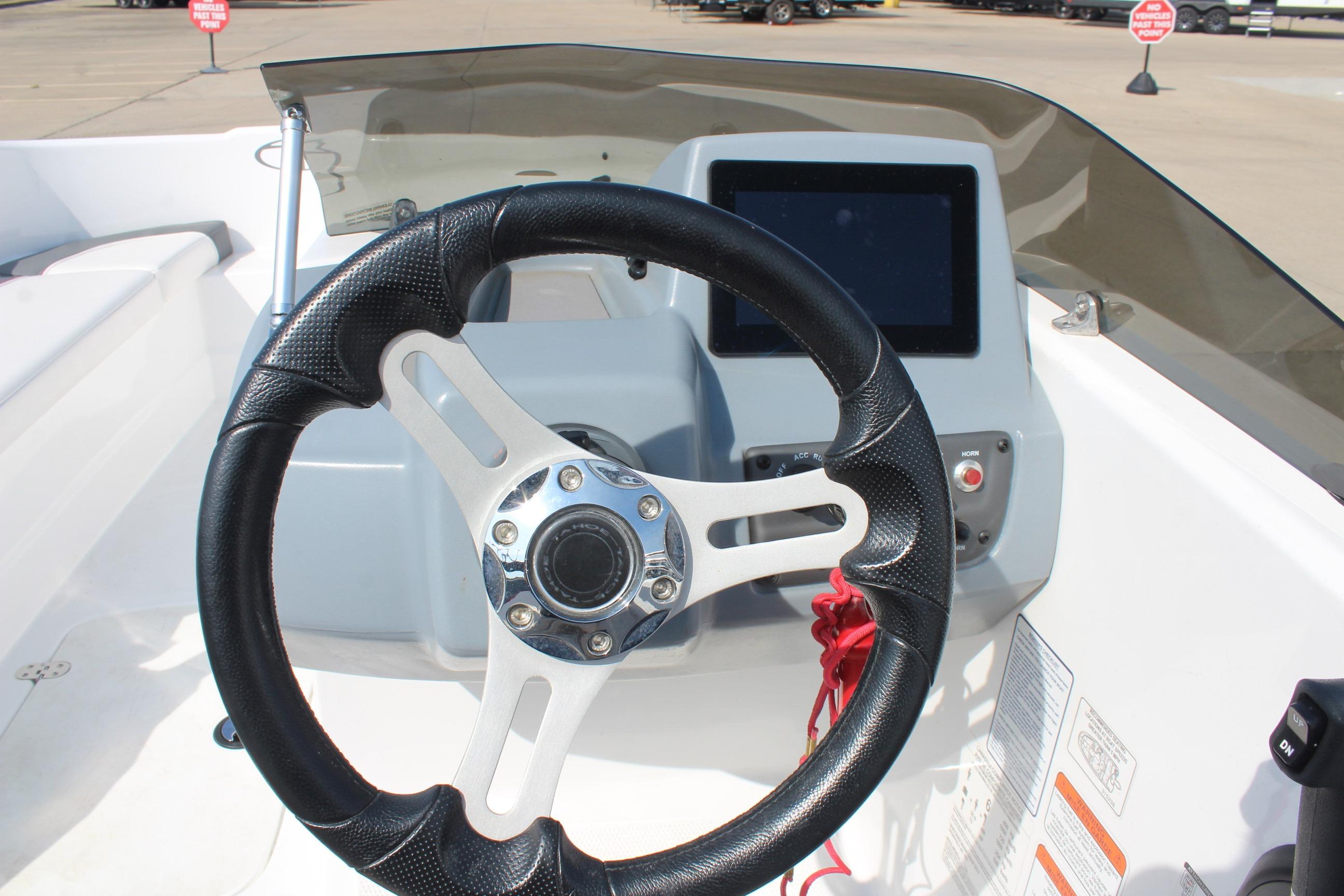 Steering wheel and dashboard of 2023 Tahoe T16 boat, featuring modern controls.