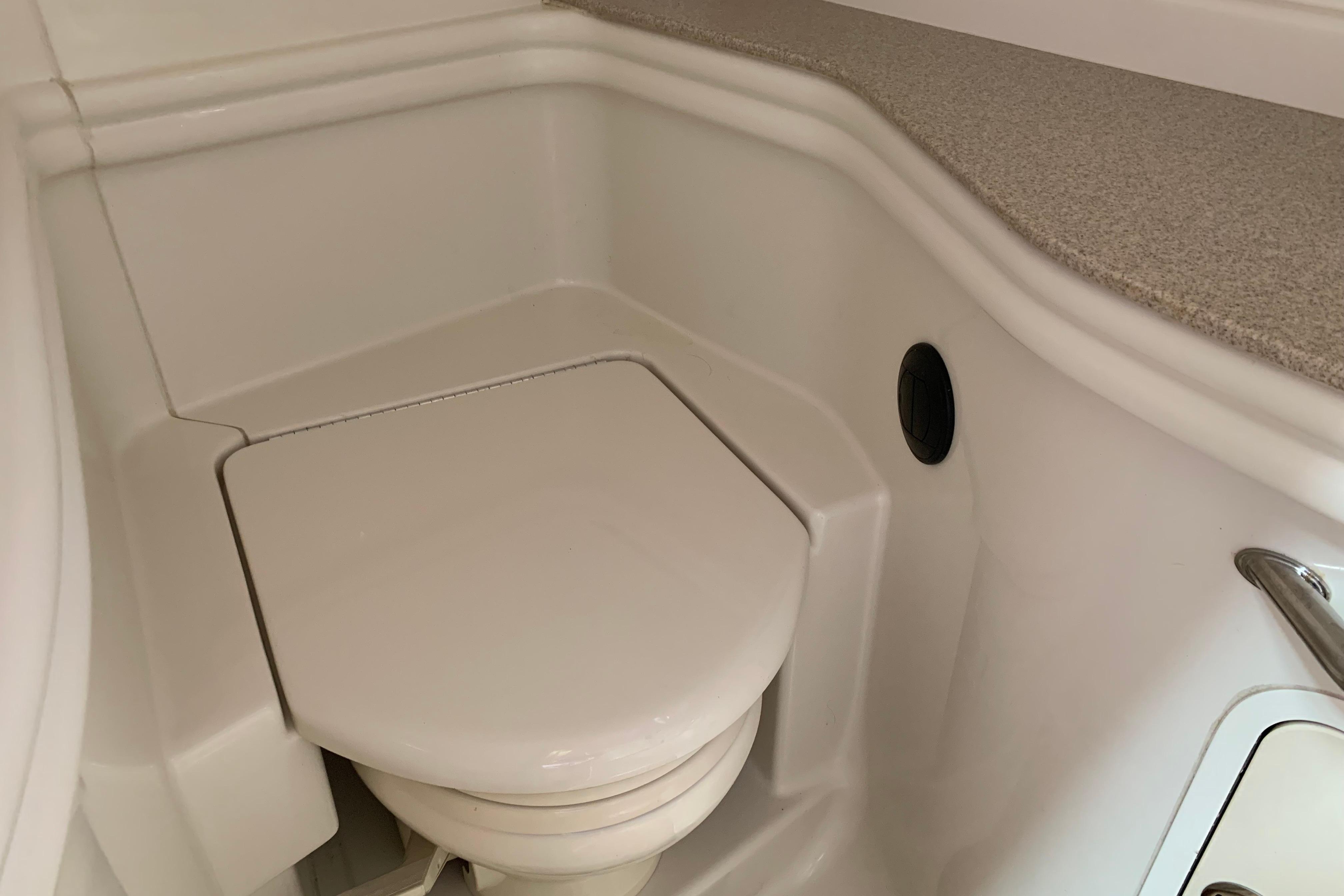 2007 Sea Ray 340 Sundancer boat bathroom with compact toilet and countertop.