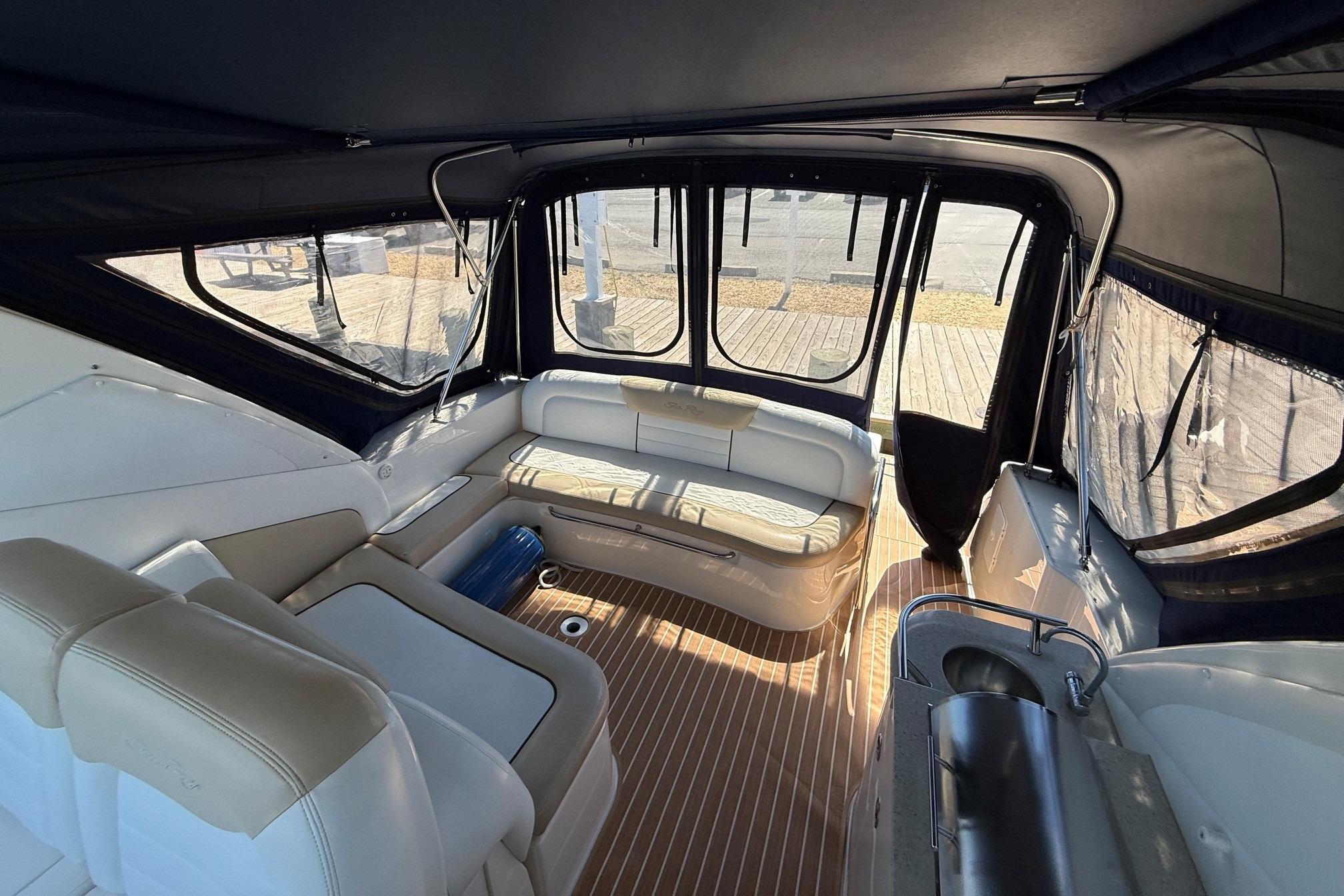 Interior of 2008 Sea Ray Sundancer 330 yacht with seating and wood flooring.