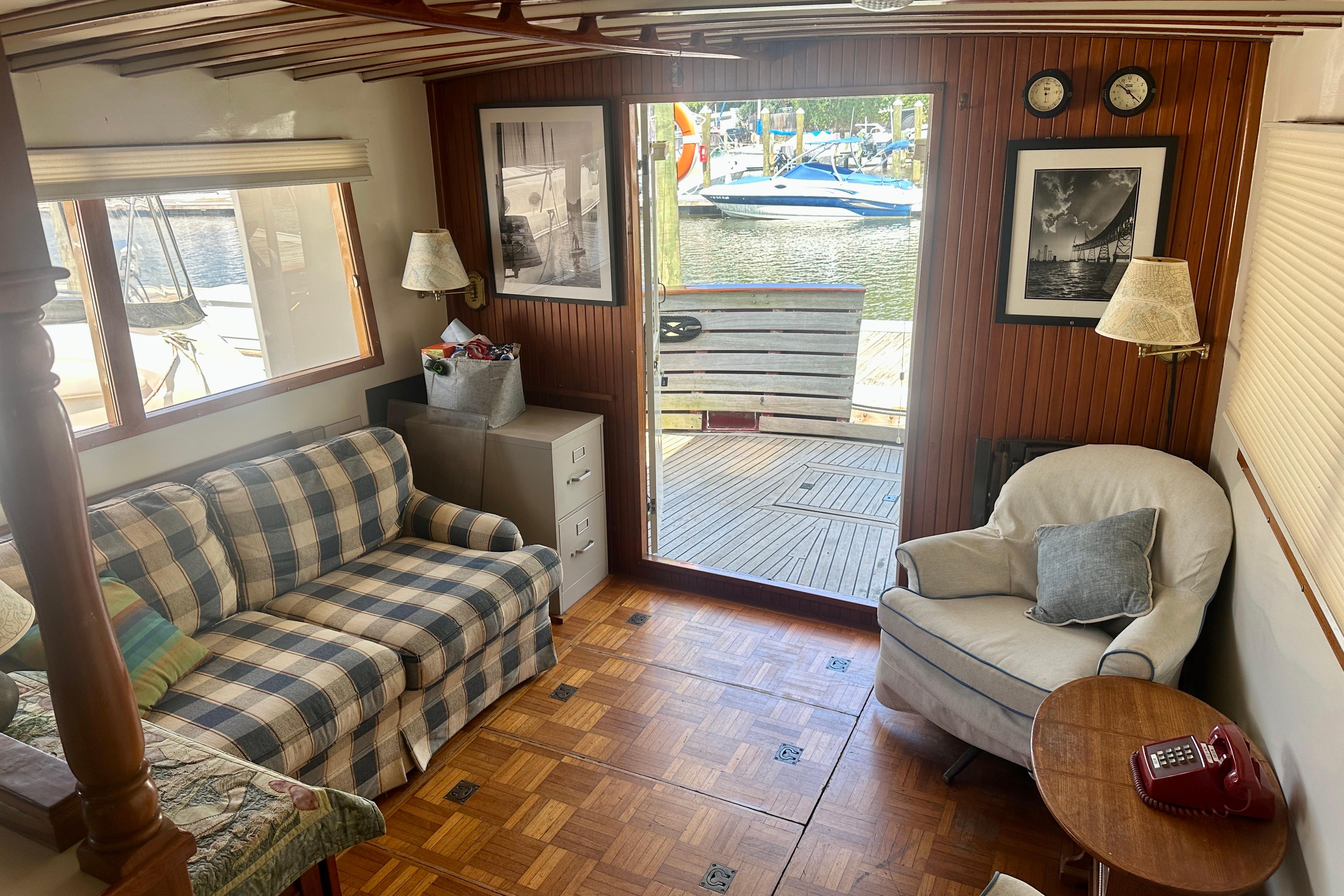 Cozy 1983 Kadey-Krogen Krogen 42 Trawler interior with plaid sofa and waterfront view.