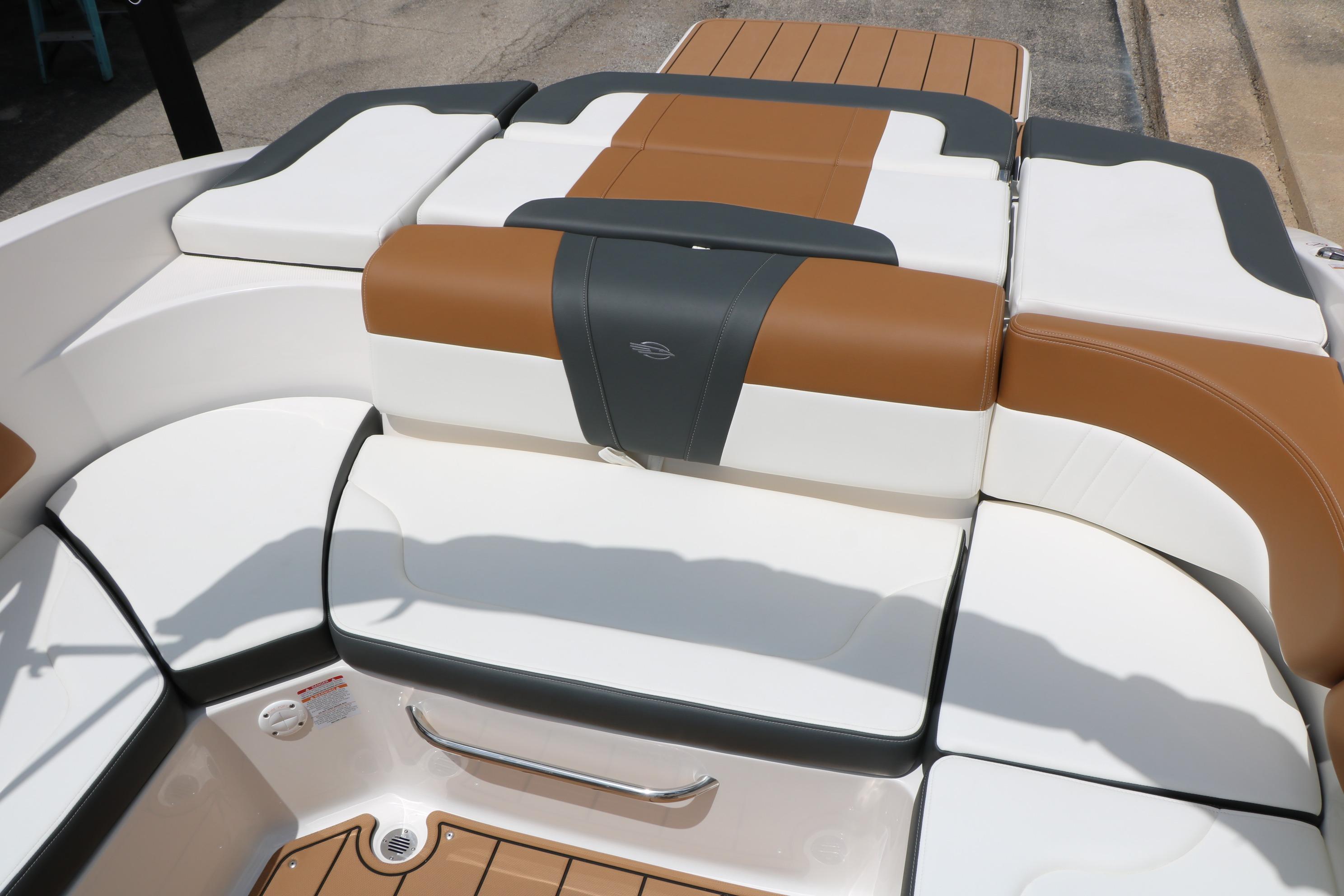 2025 Chaparral 23 SSi boat interior with stylish brown and white seating.