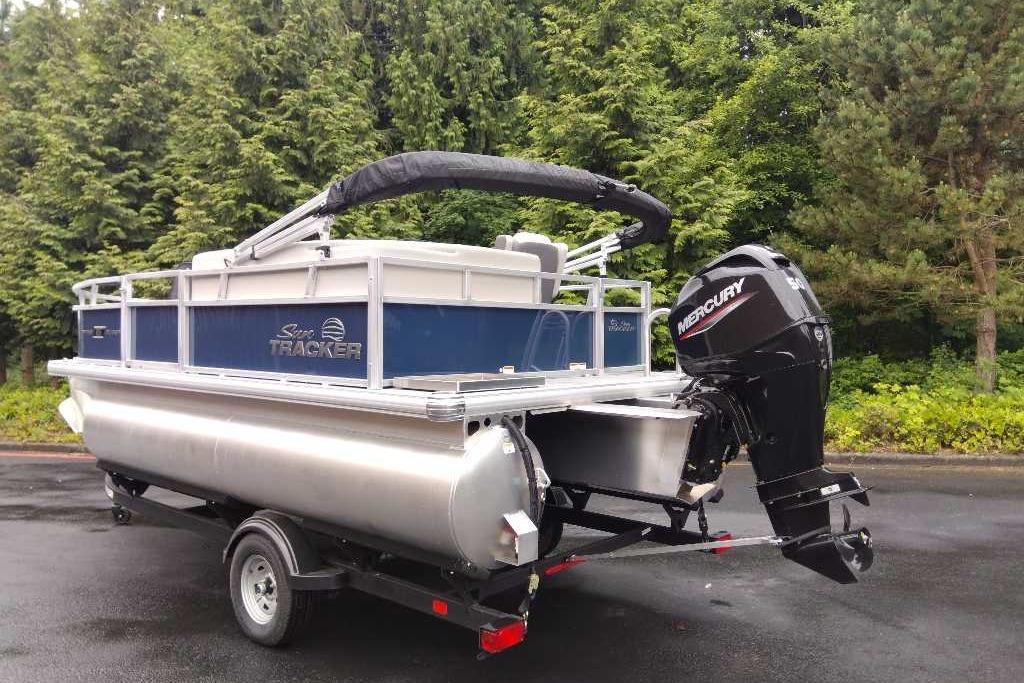 2026 Sun Tracker Bass Buggy 16 XL Select pontoon boat with Mercury outboard motor on trailer.