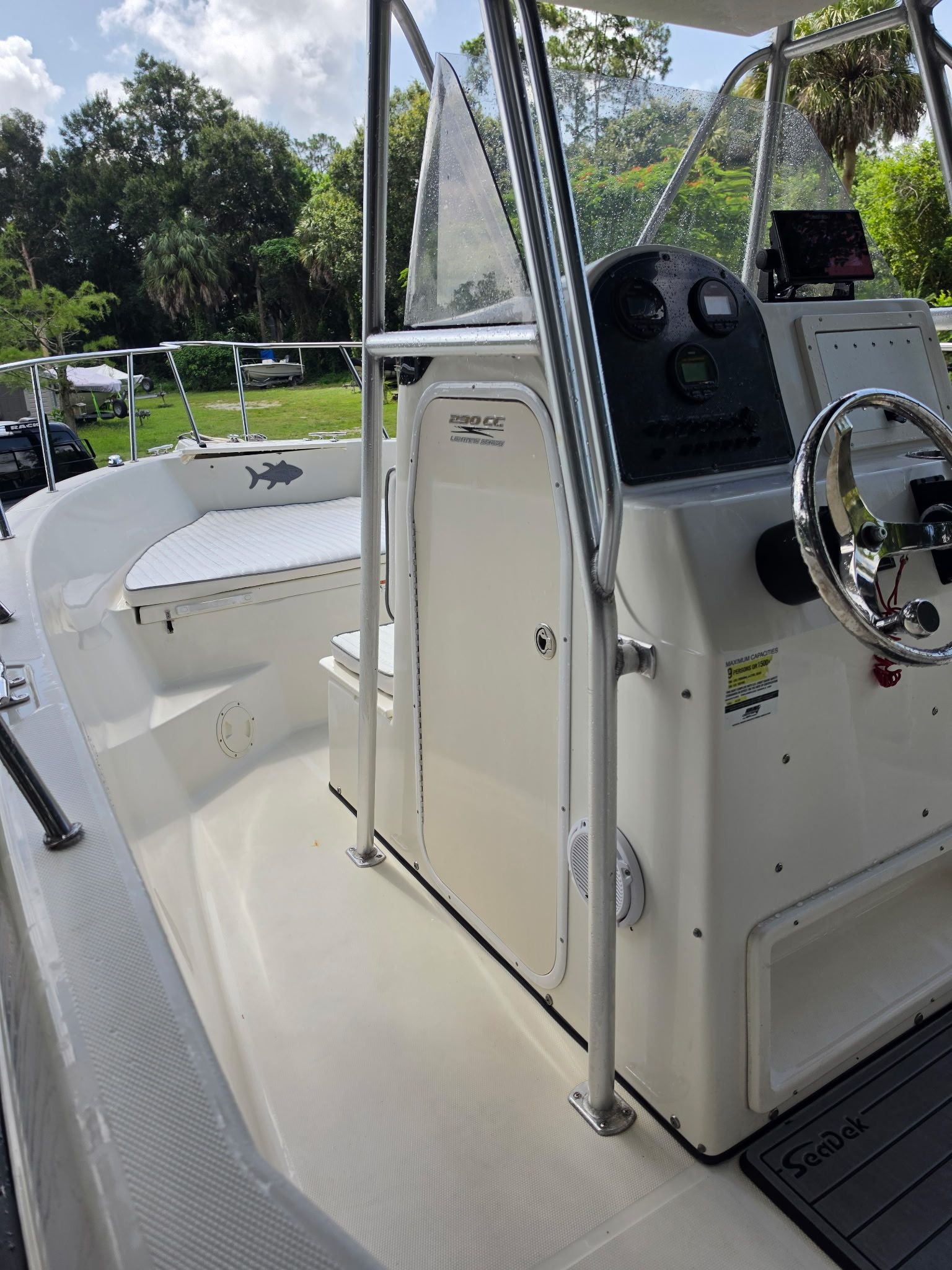 The image shows the cockpit of a 2004 Hydra-Sports Lightning 230 CC boat.