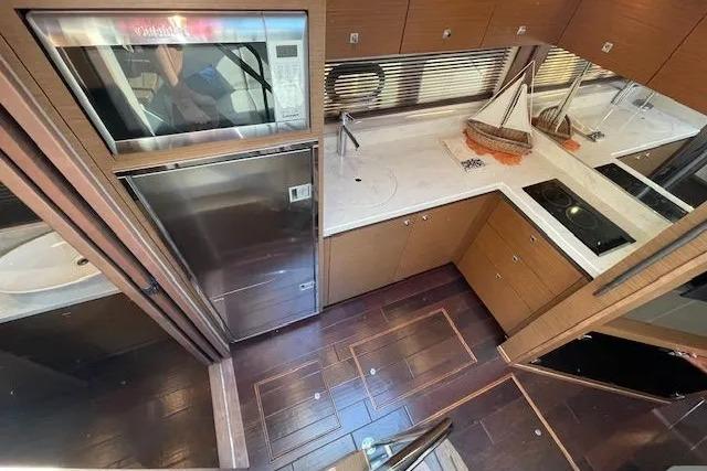 Luxurious kitchen interior of 2016 Sea Ray Sundancer 510 yacht with modern appliances.