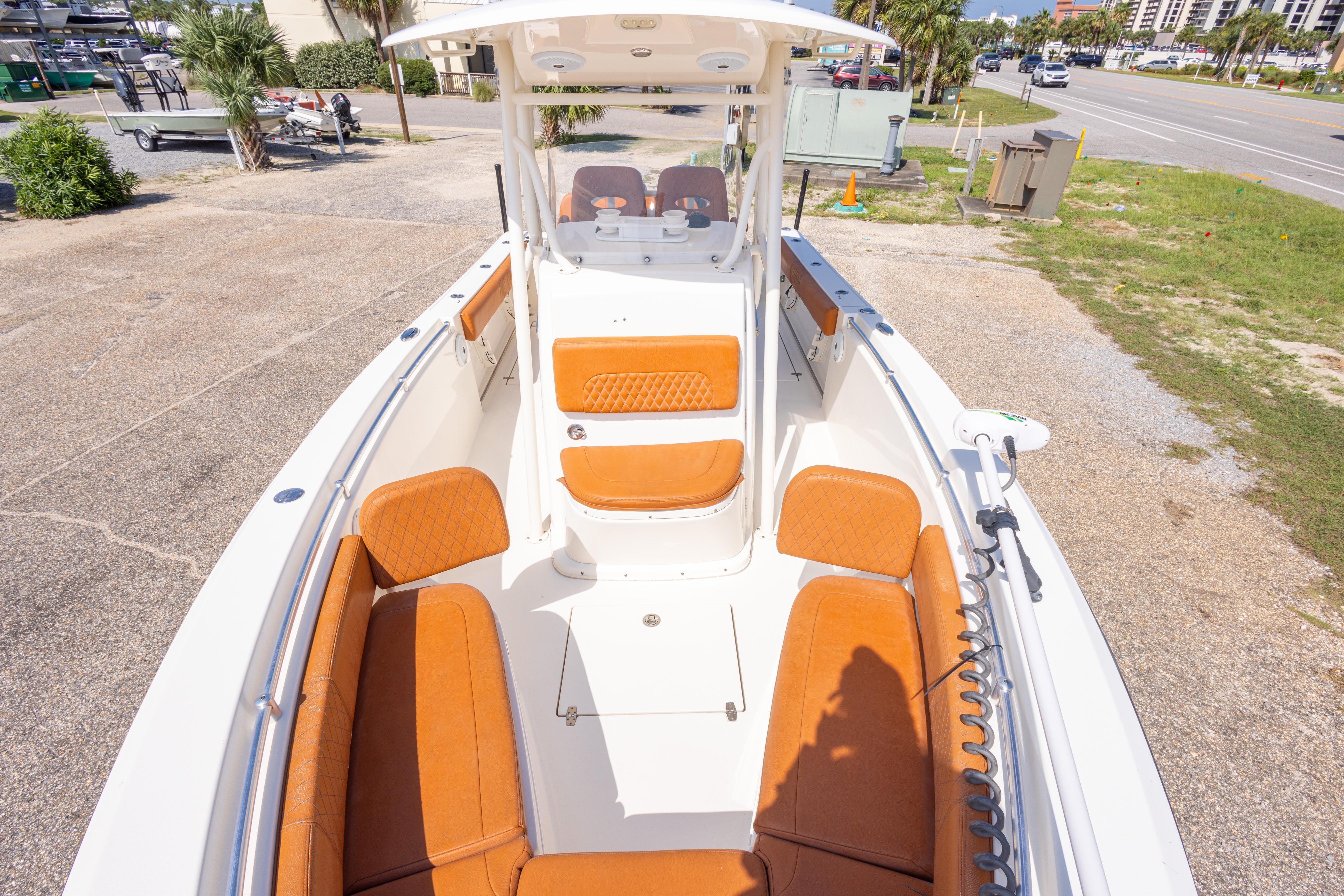 2017 Cobia 261 Center Console boat with tan seating, docked on a sunny day.