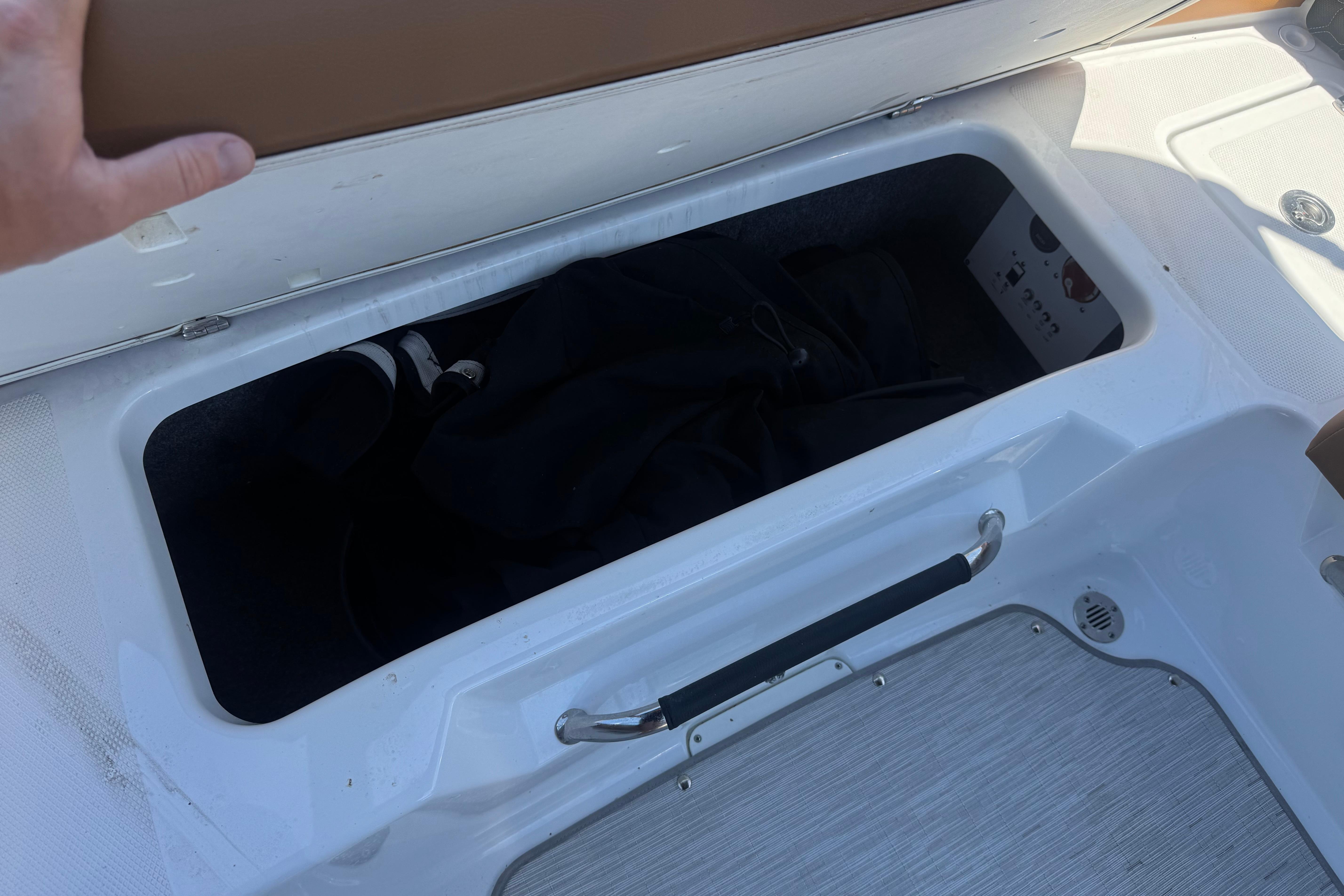 Open storage compartment on 2022 Four Winns H4 boat, showcasing interior space.
