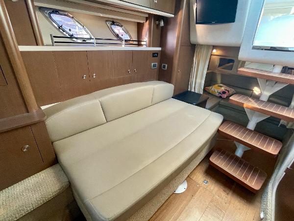 Interior of 2014 Sea Ray 330 Sundancer with beige seating and wooden accents.