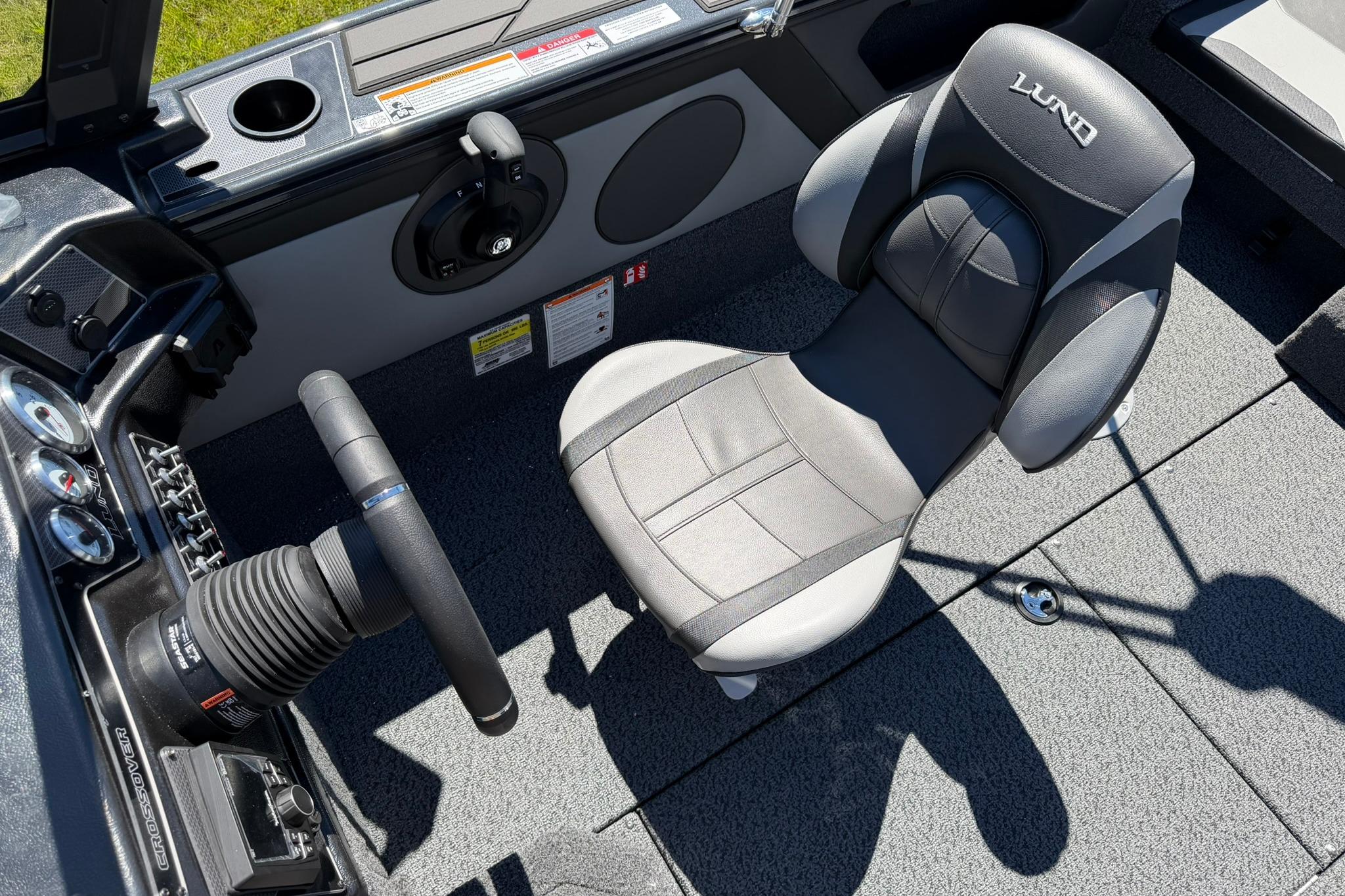 2027 Lund 1775 Crossover XS boat interior with steering wheel and cushioned seat.