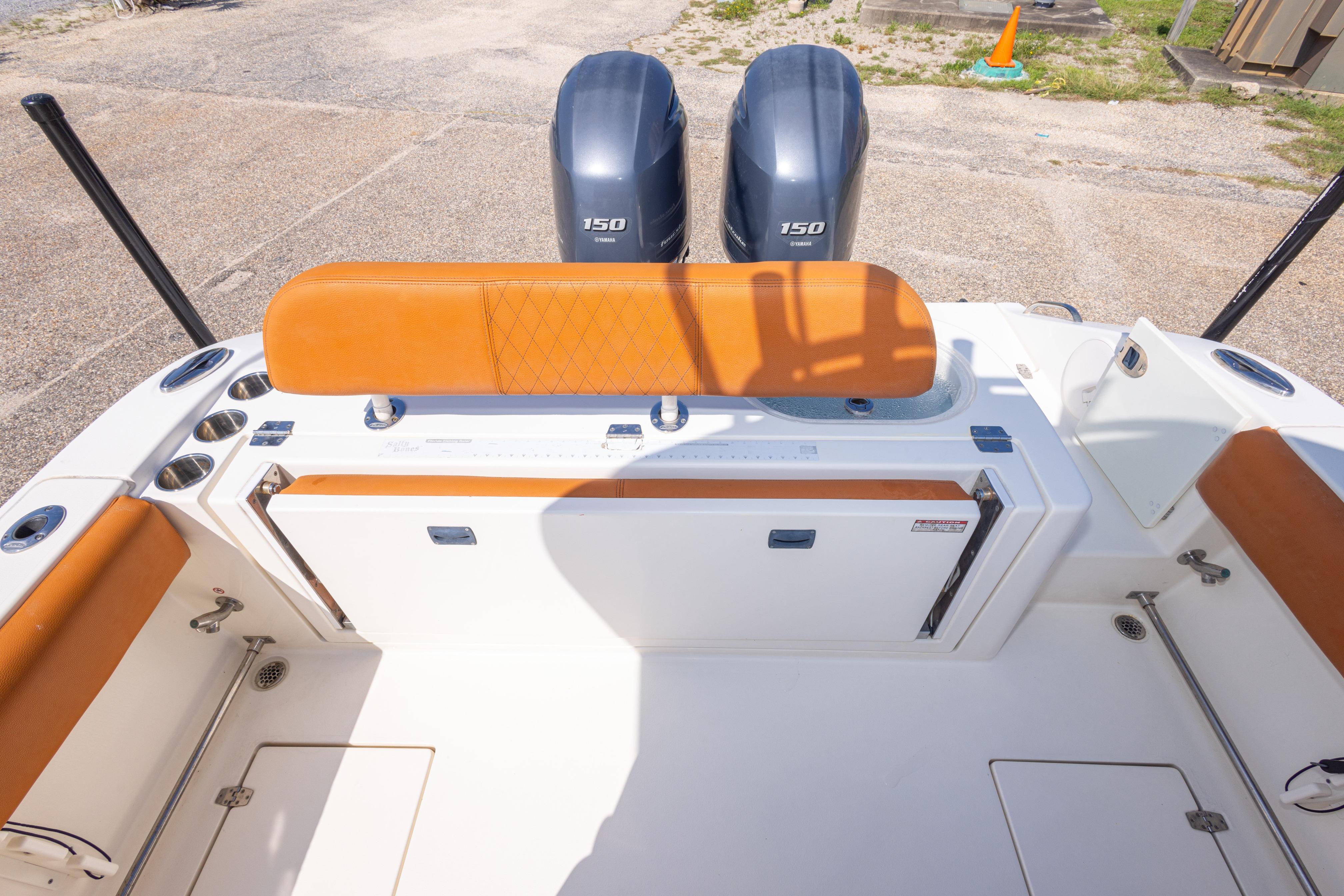 2017 Cobia 261 Center Console boat with twin 150 engines and orange seating.
