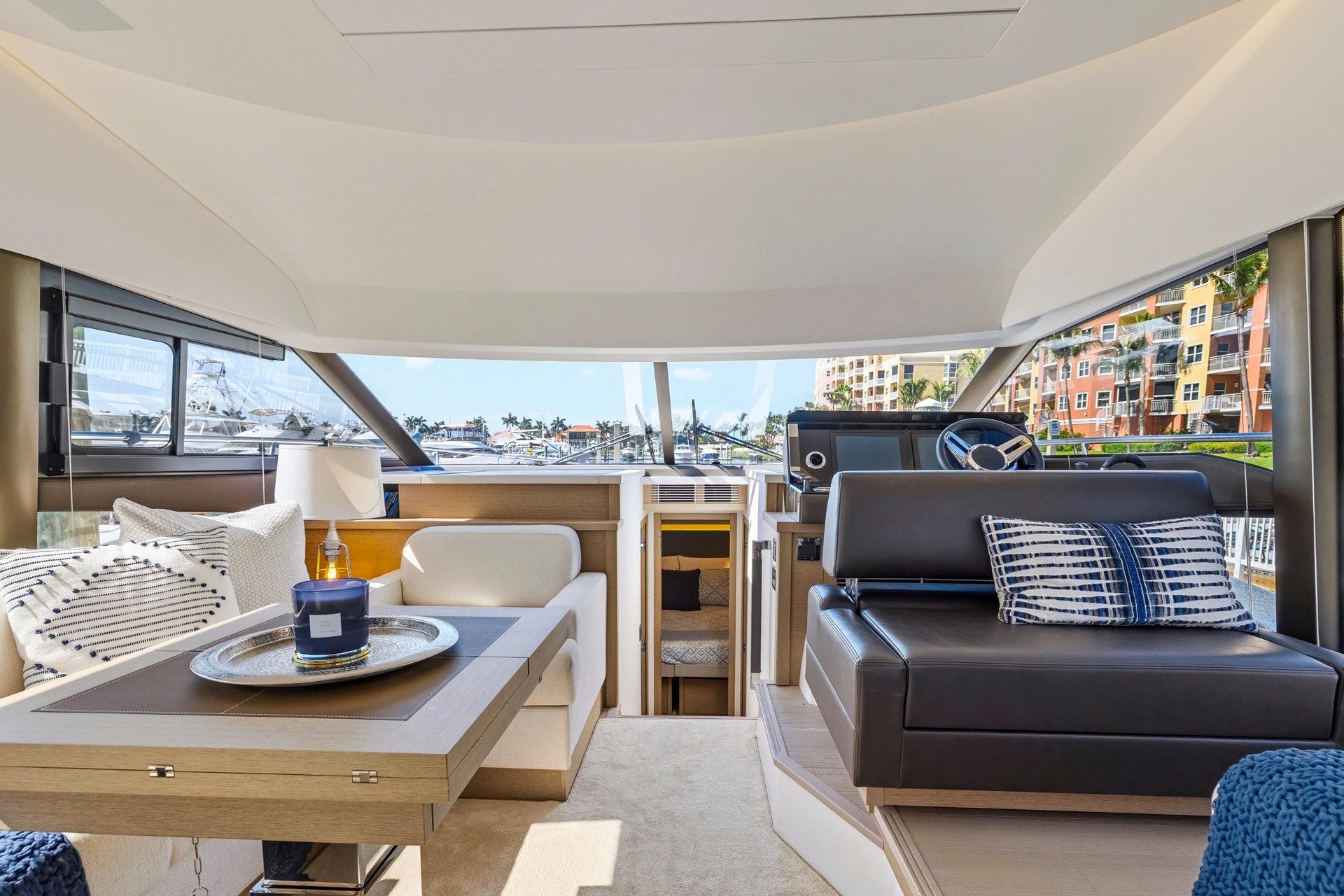 Luxurious interior of 2022 Prestige 520 yacht with modern seating and elegant decor.