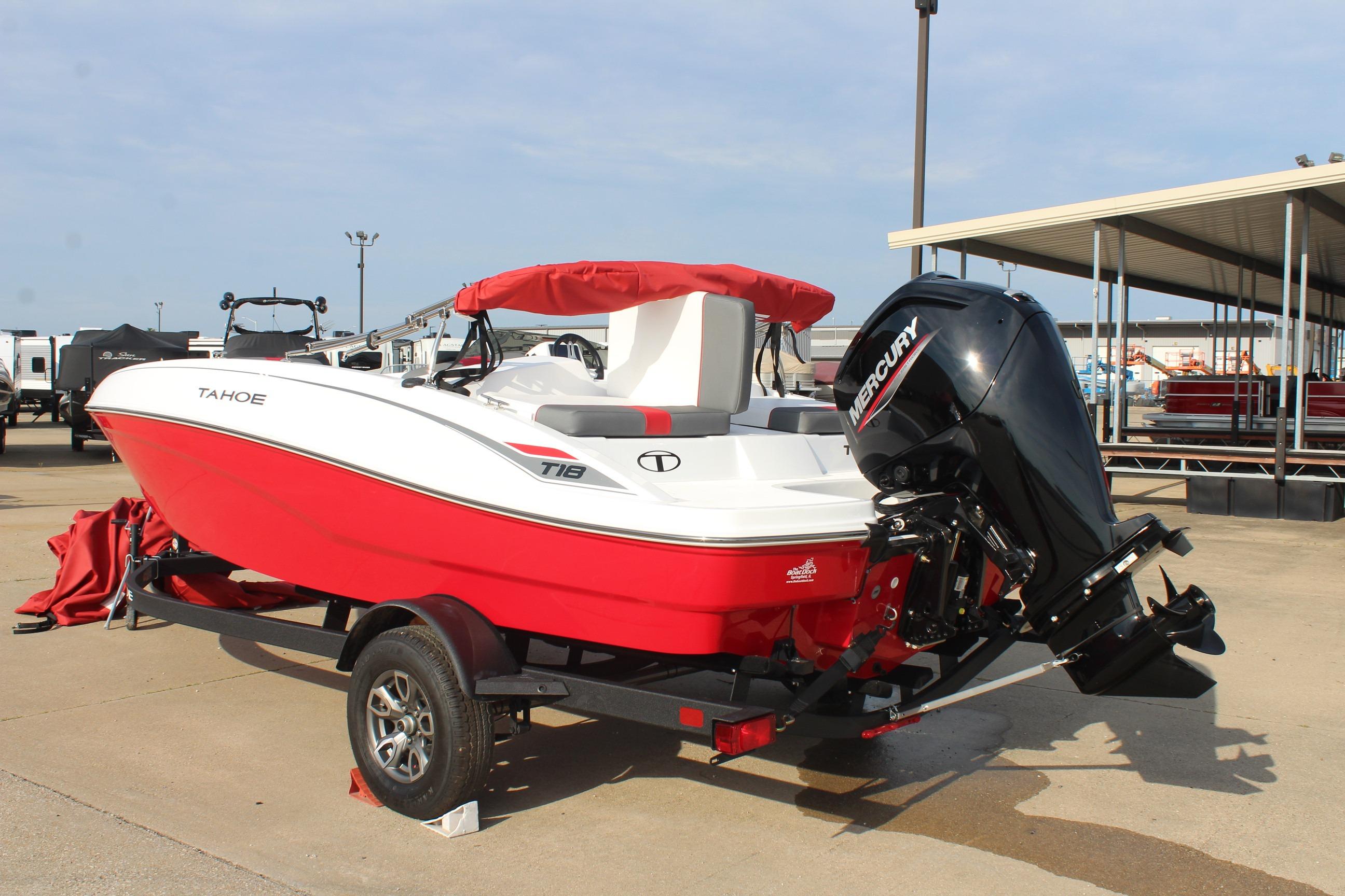 2026 Tahoe T18 boat with red hull and Mercury outboard motor on trailer.