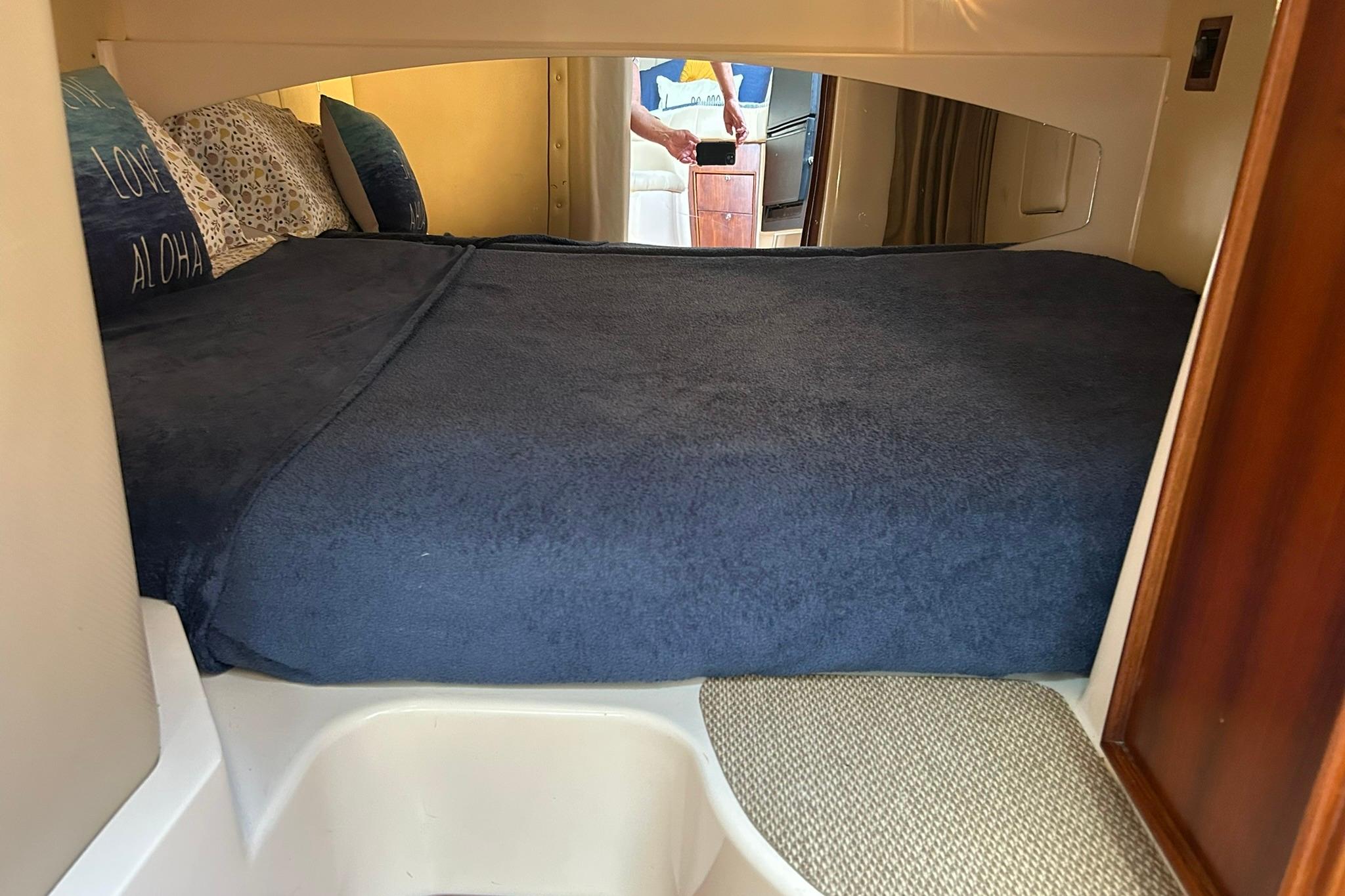 2007 Grady-White Express 360 cabin interior with cozy bed and pillows.
