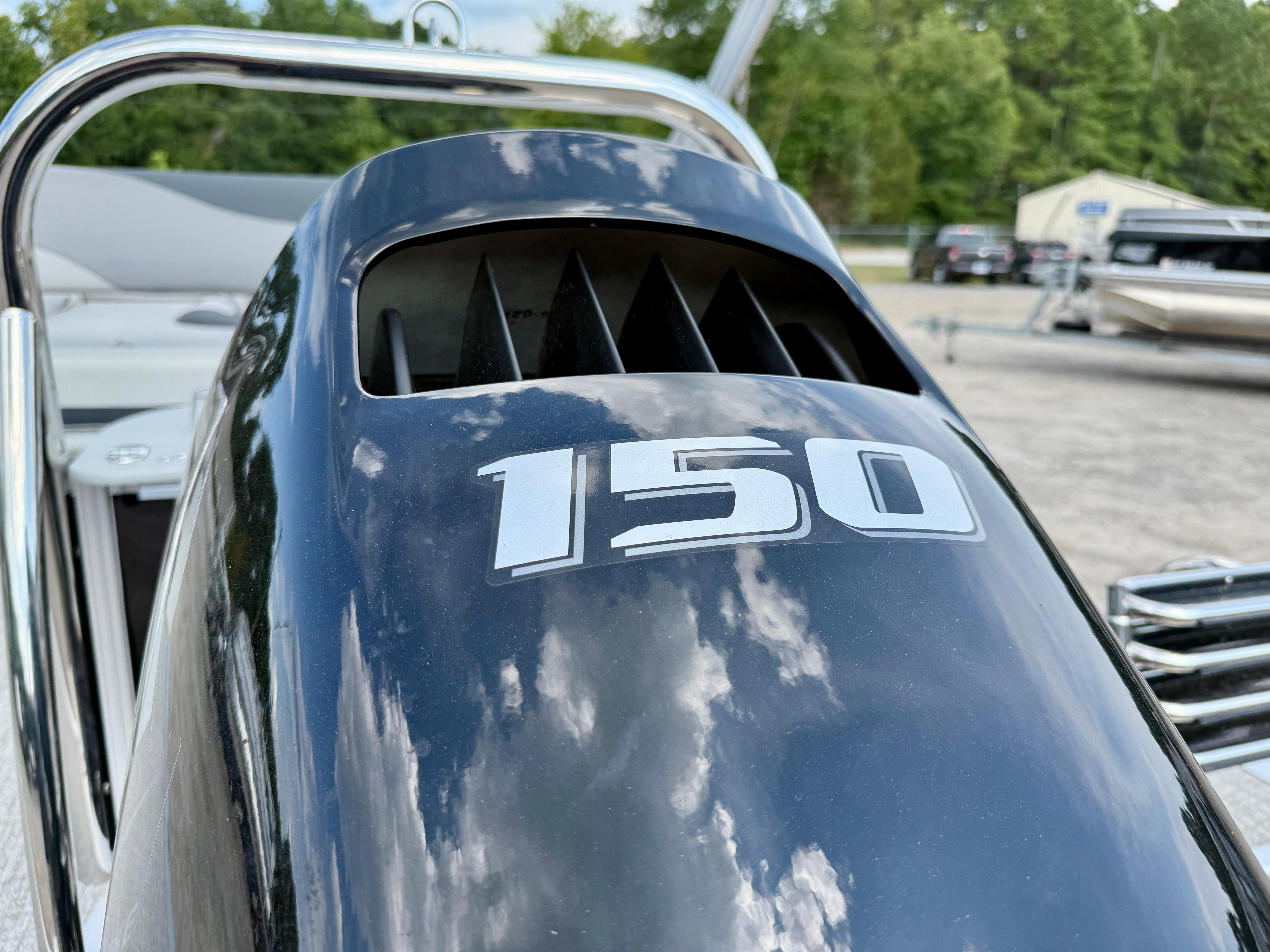 Outboard motor with "150" label on Avalon LSZ Cruise Rear Bench, 2025 model.