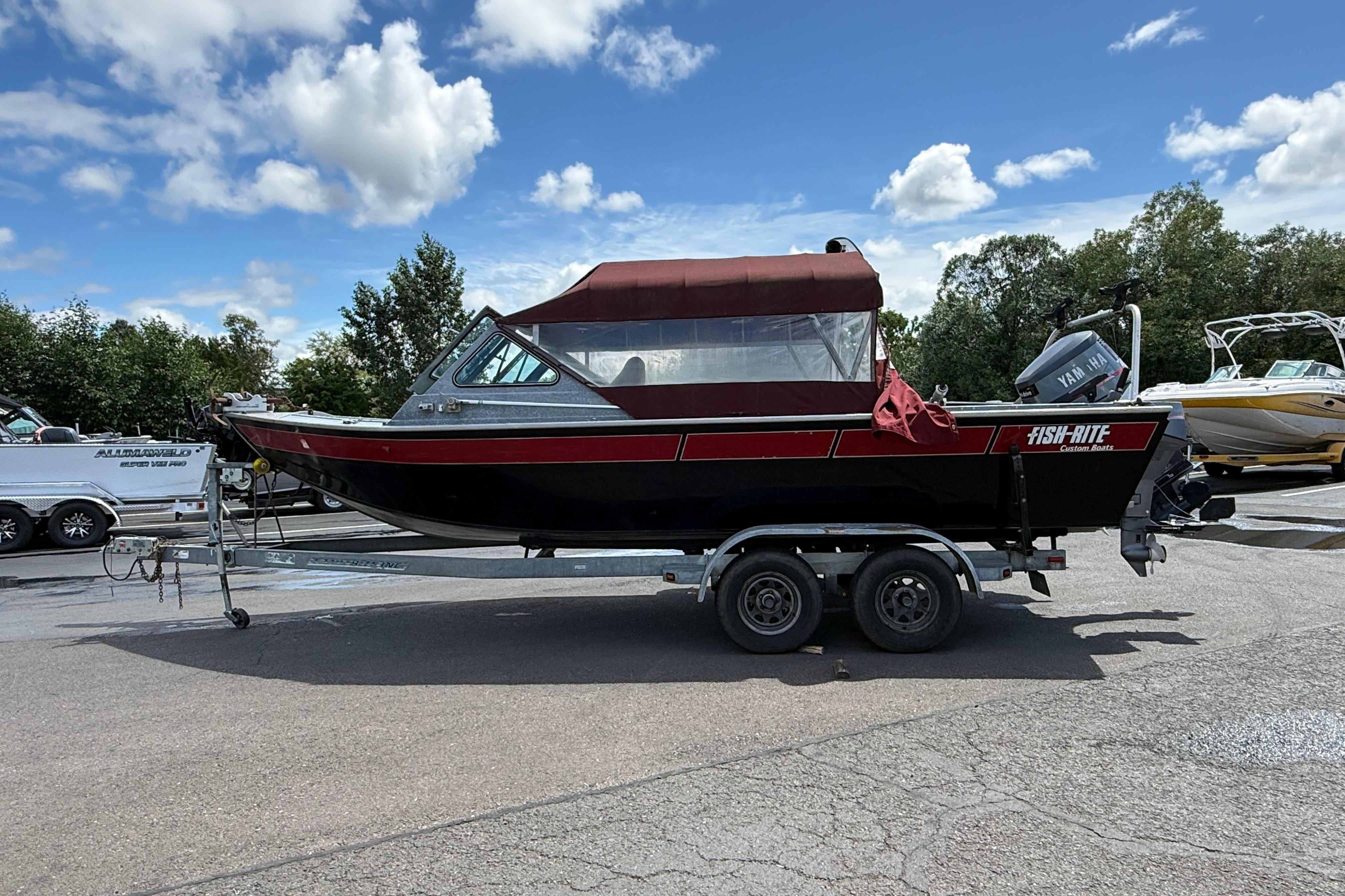 1991 Fish Rite Fish Custom 22' boat on trailer, under blue sky with clouds.