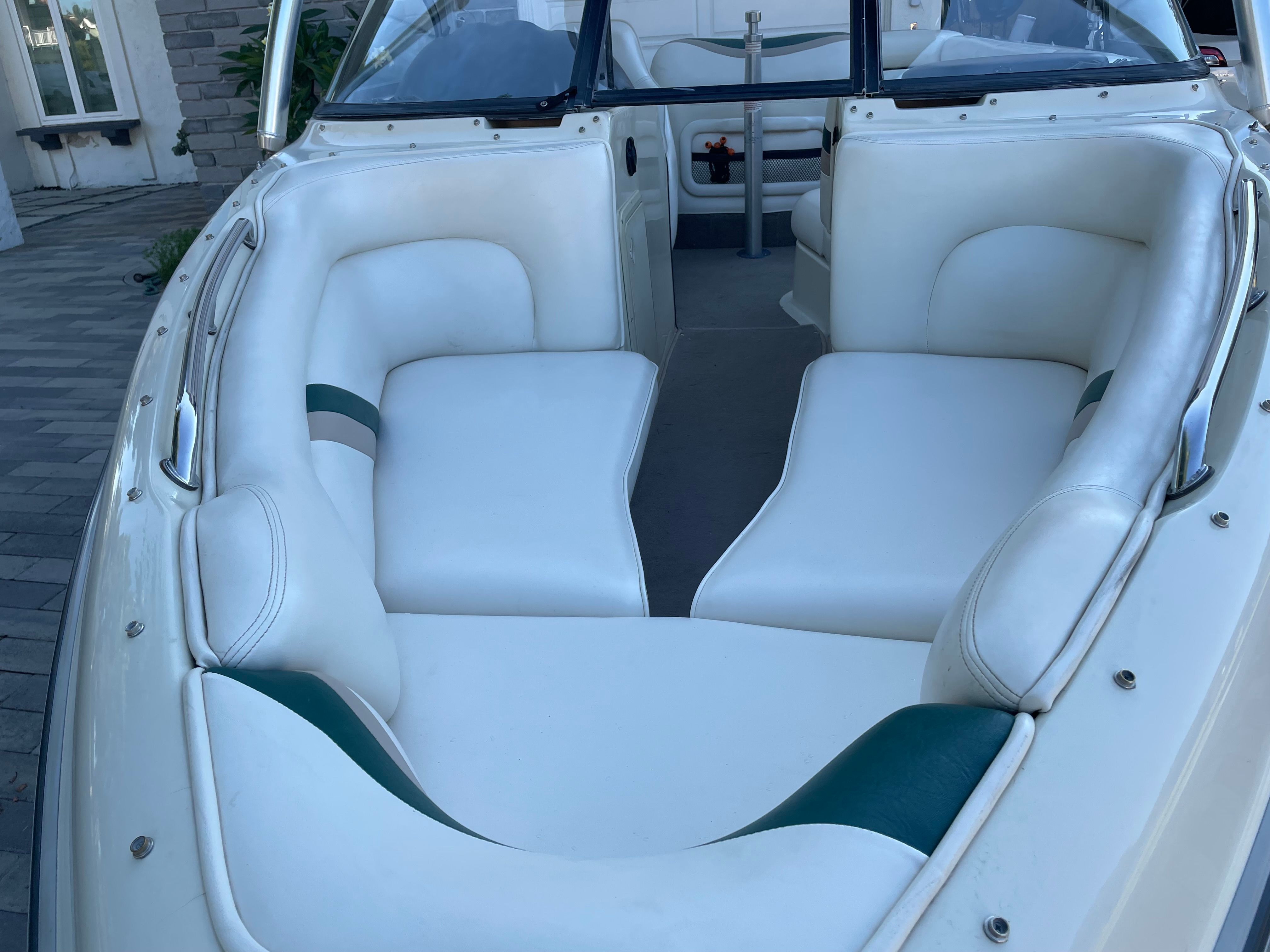 Interior view of a 1998 Tigé Pre 2100 with white upholstery and green accents.