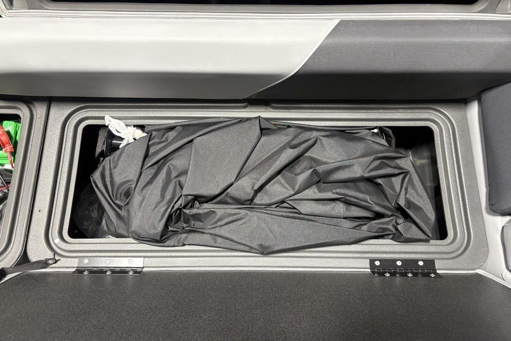 Storage compartment of 2026 Sun Tracker PARTY BARGE® 20 DLX with black cover inside.