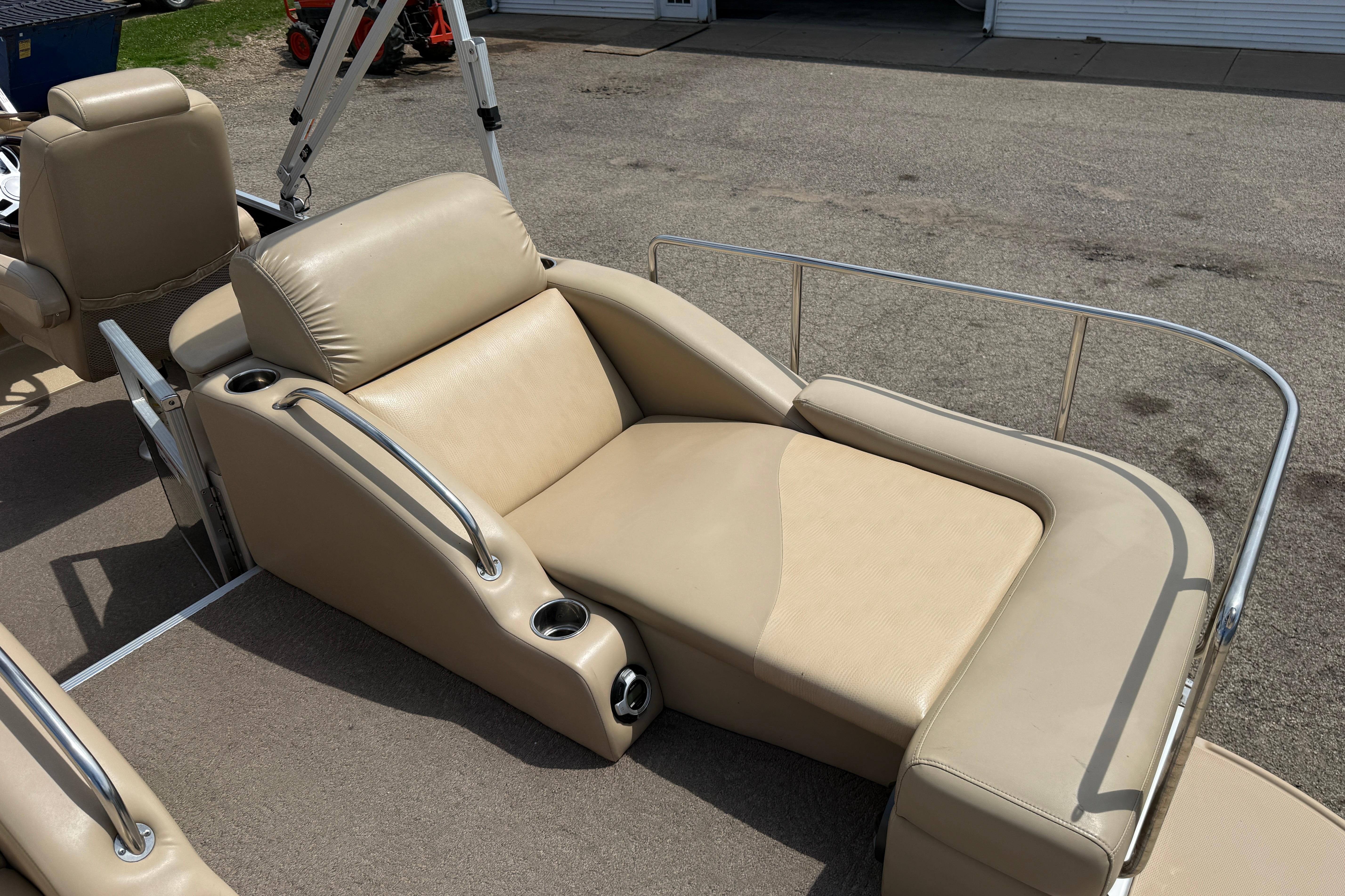 Luxurious seating on a 2011 Bennington 2575QCW I/O pontoon boat, featuring beige upholstery.
