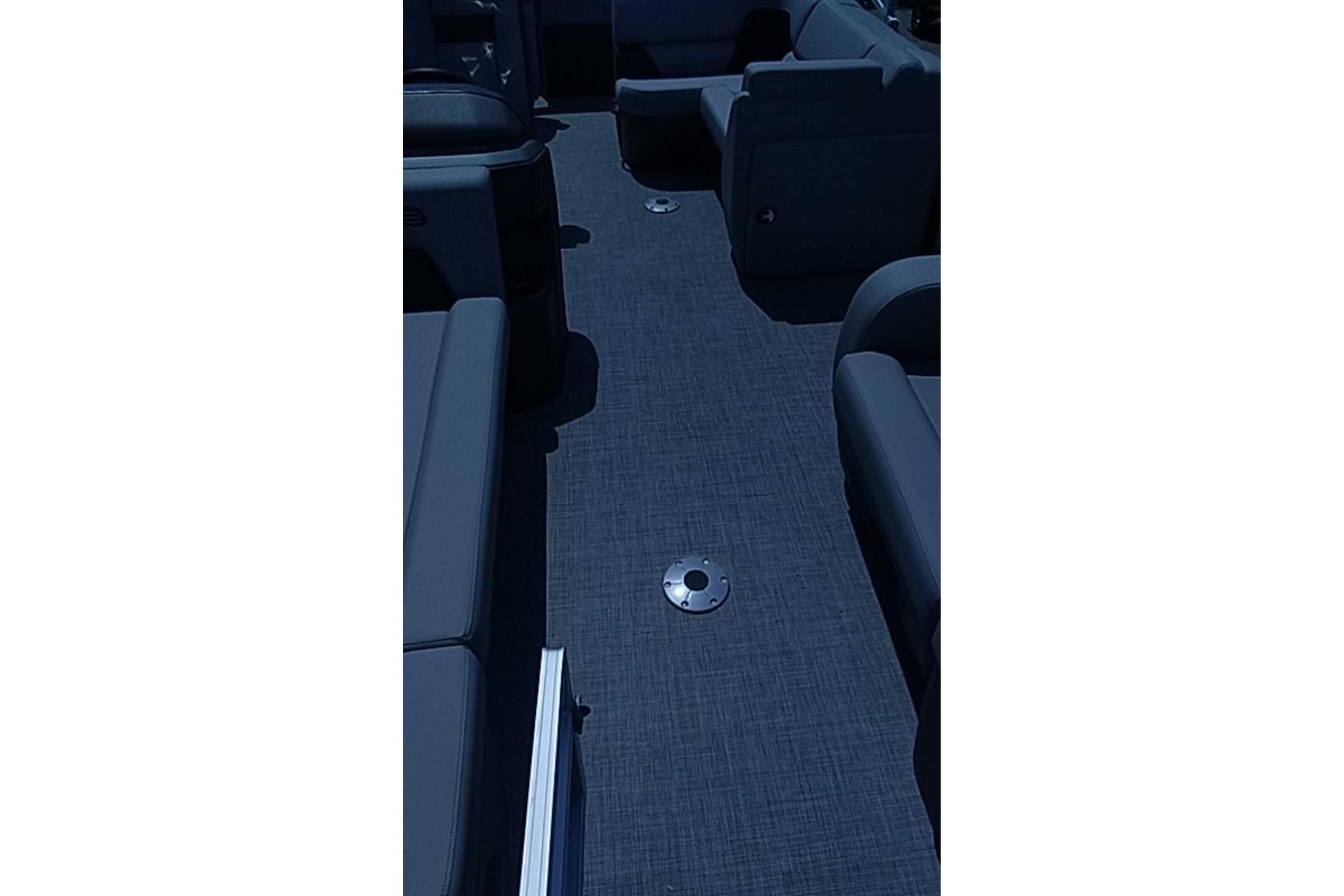 Interior view of 2026 Sun Tracker SportFish 22 DLX pontoon boat with seating and flooring.