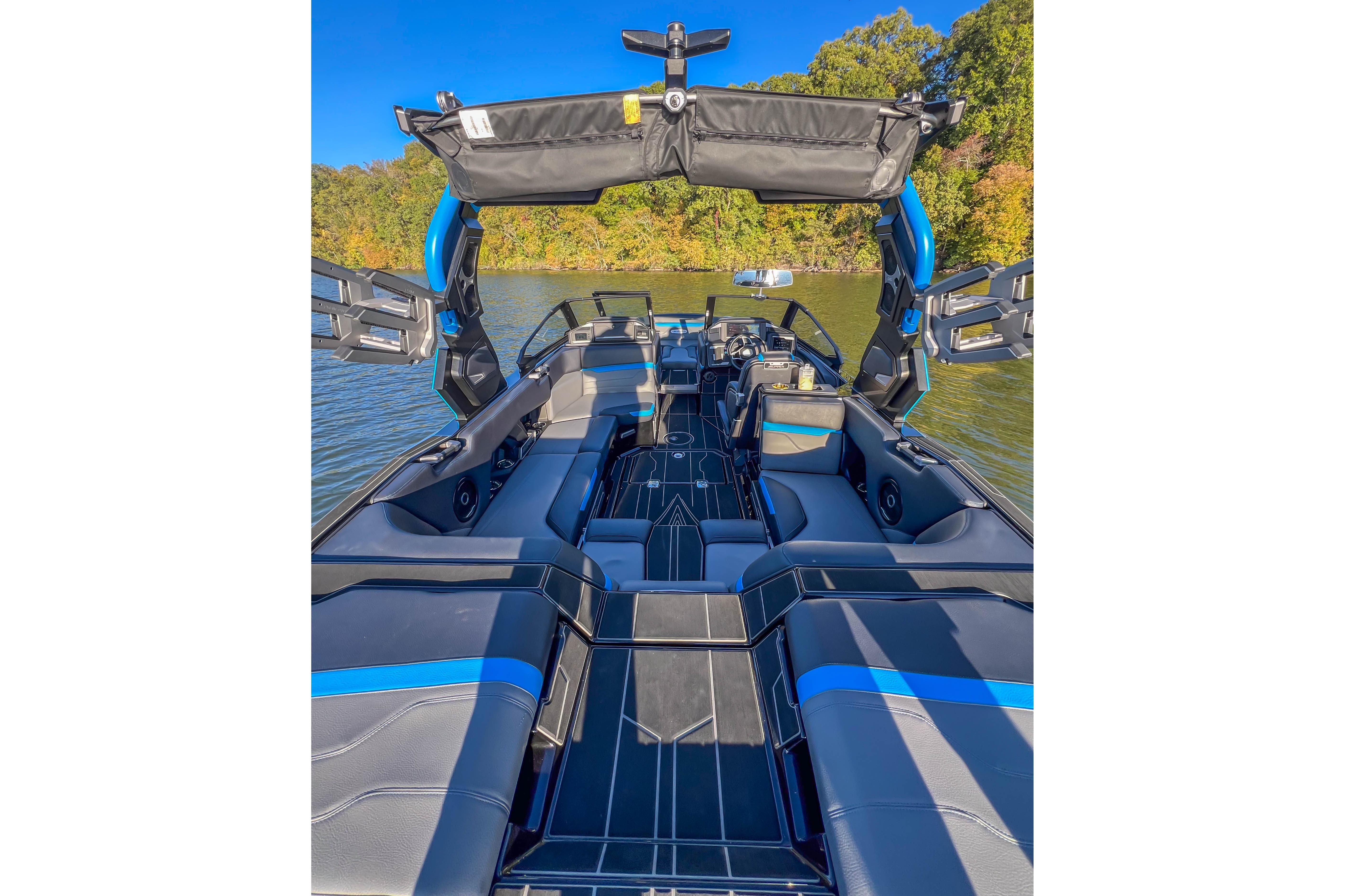 2024 Supra SV 400 boat interior with sleek seating and advanced features on a sunny lake.
