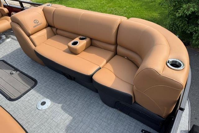 Luxurious seating on 2026 Regency 230 DL boat with tan upholstery and cup holders.