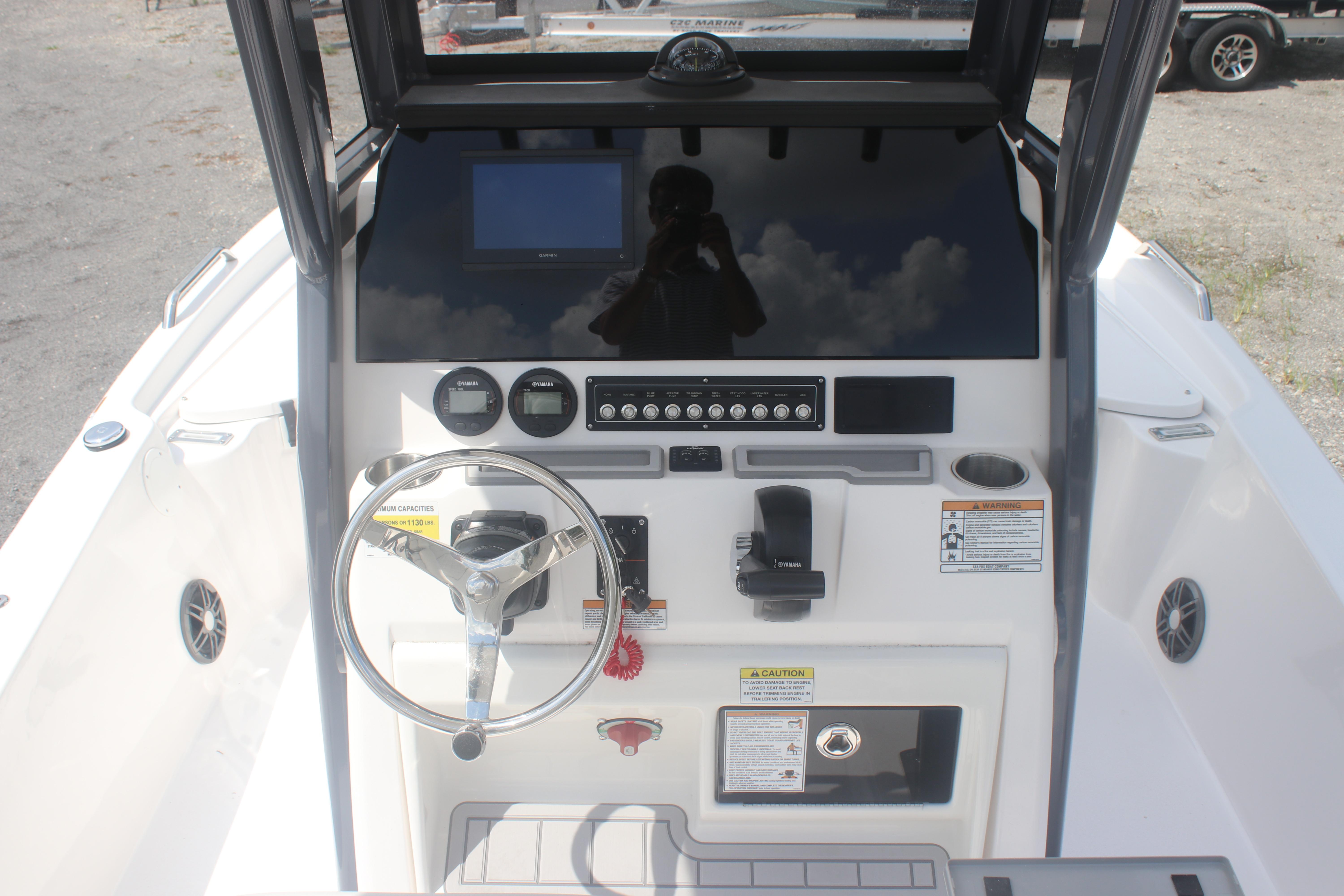 2025 Sea Fox 231 Bay Fox boat dashboard with steering wheel and control panel.