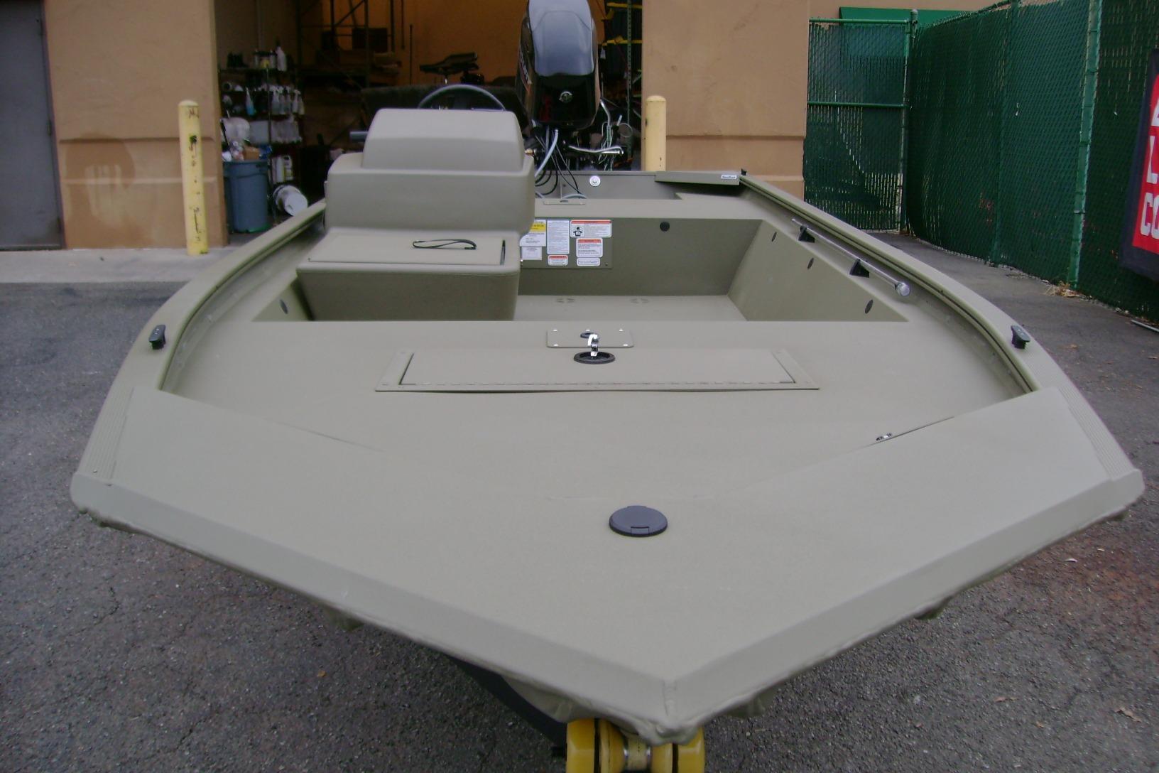 2026 Tracker Grizzly 1648 SC boat, olive green, parked outdoors, front view.