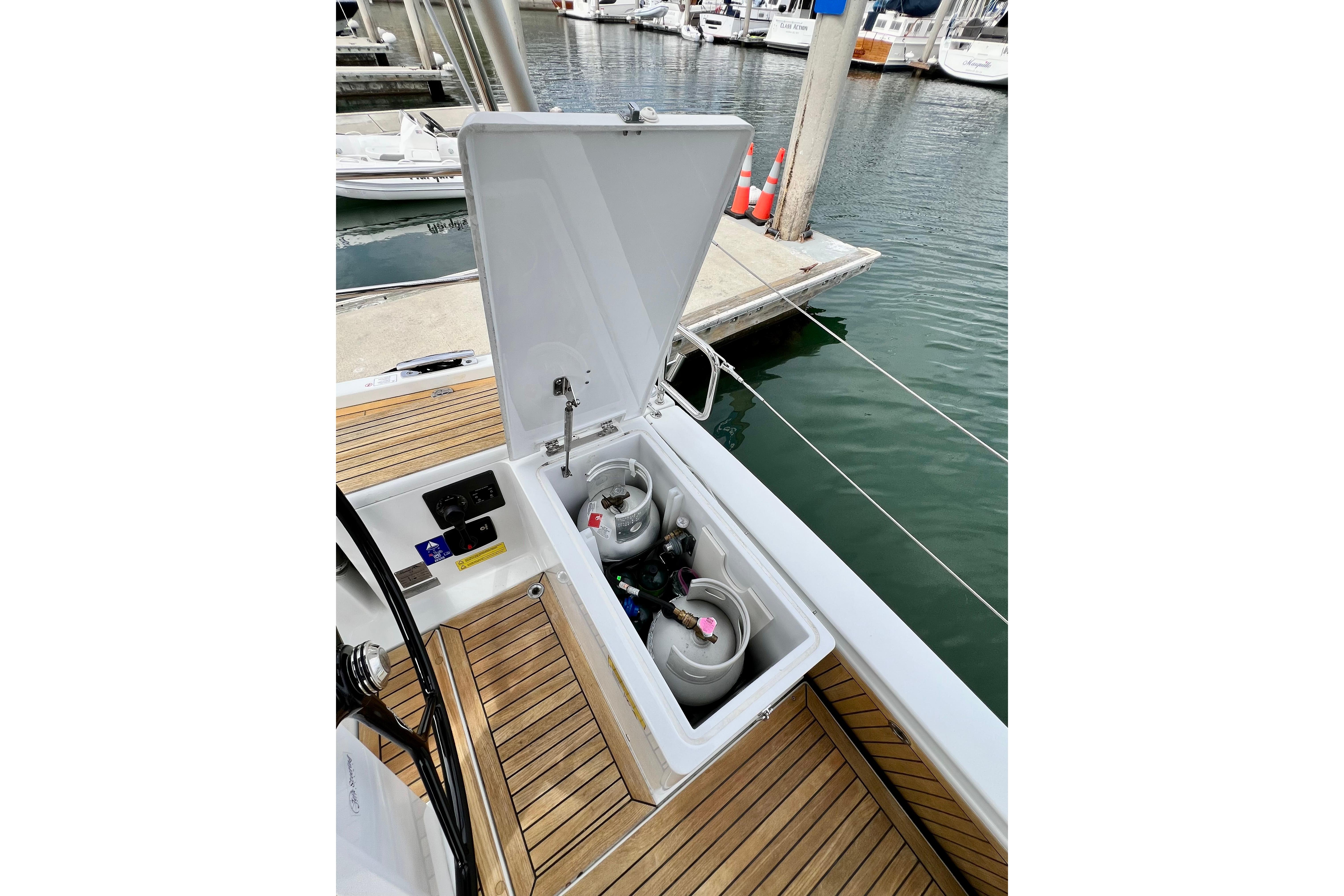 Open storage compartment on 2016 Hanse 455 yacht, revealing gas cylinders on deck.