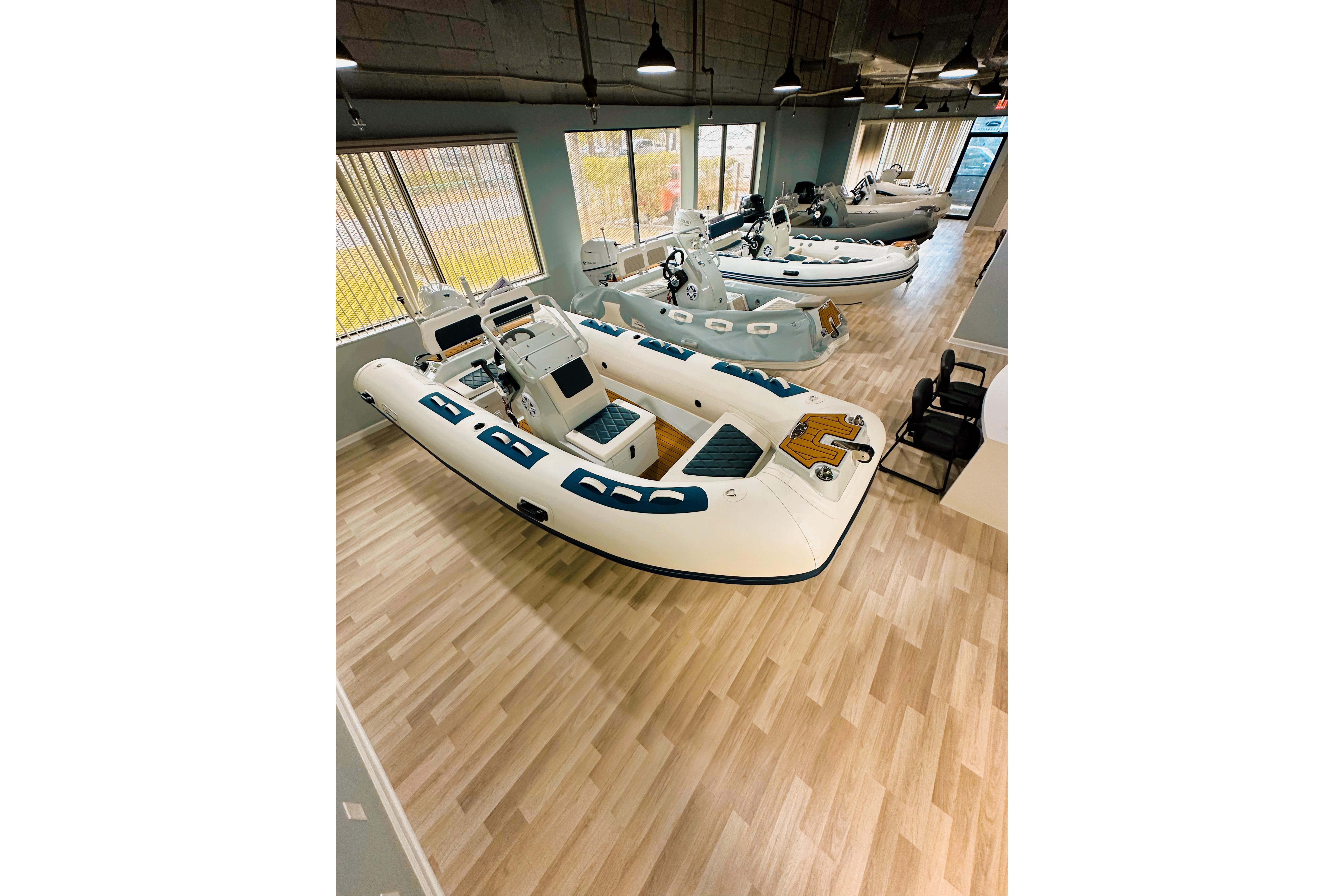 2026 East Marine 320 Electric Tohatsu Alaris boats displayed in showroom.
