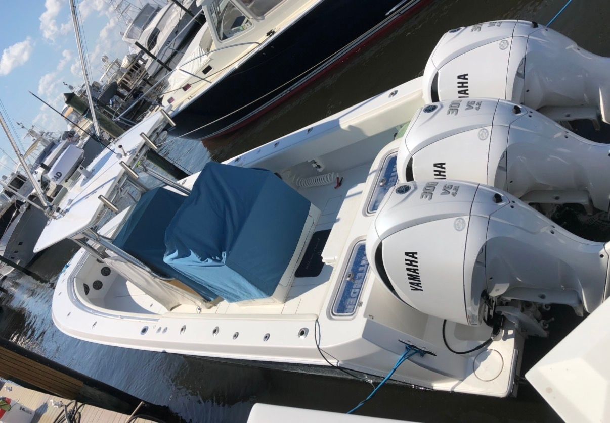 2009 Contender 33 Tournament boat with Yamaha engines docked.