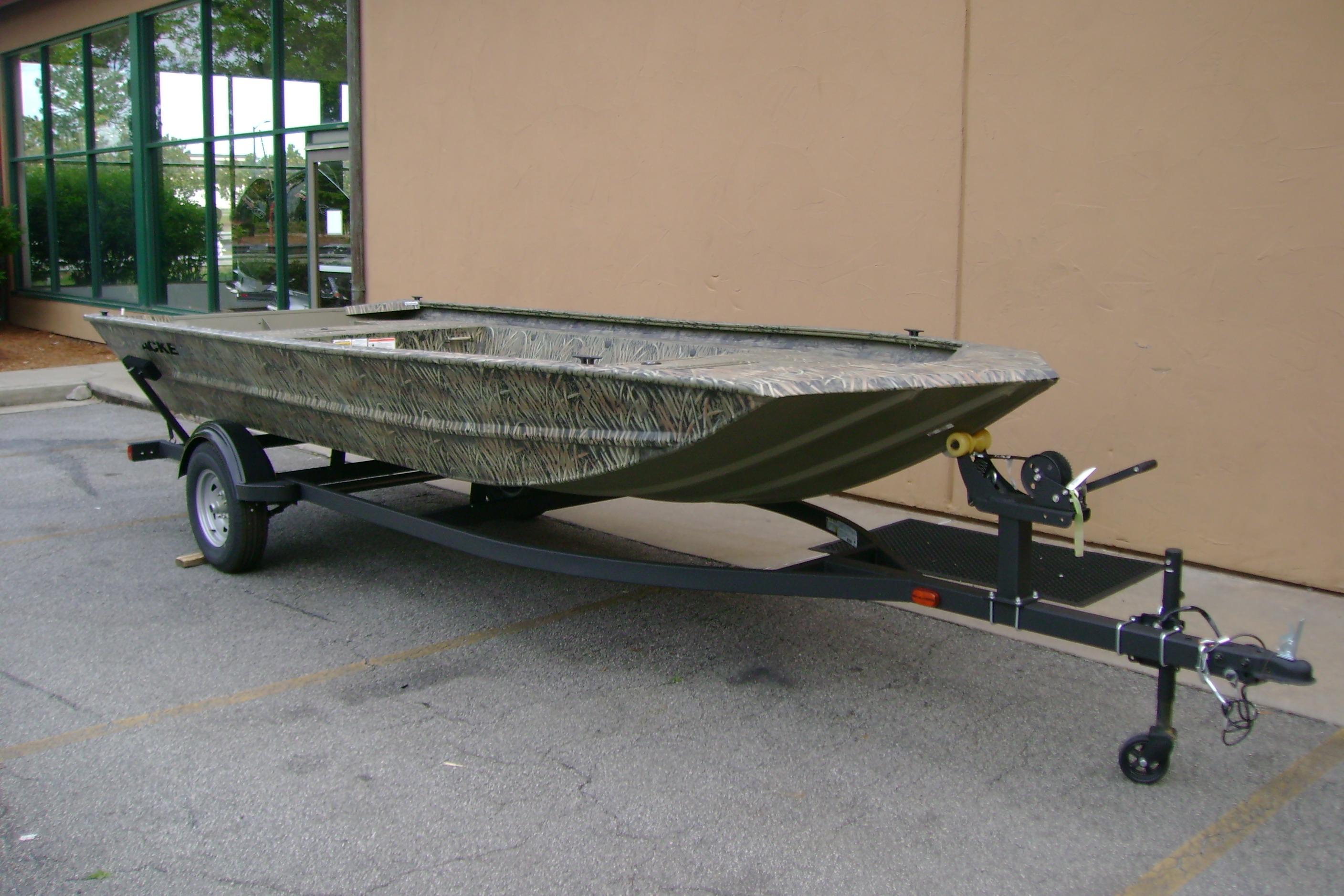 2026 Tracker Grizzly 1754 Utility boat on trailer, parked outdoors.