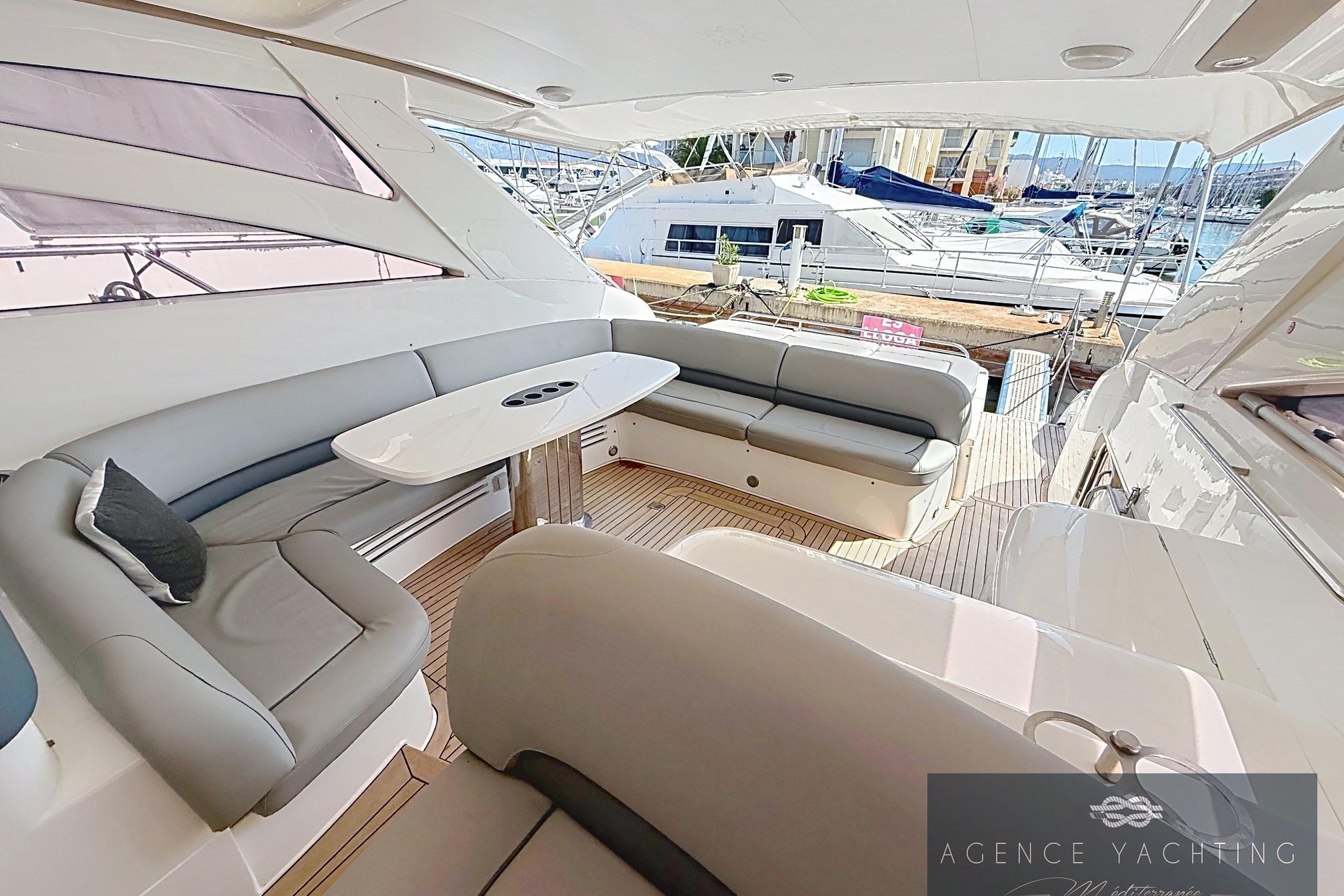 Luxurious 2004 Princess V58 yacht interior with elegant seating and sleek design.
