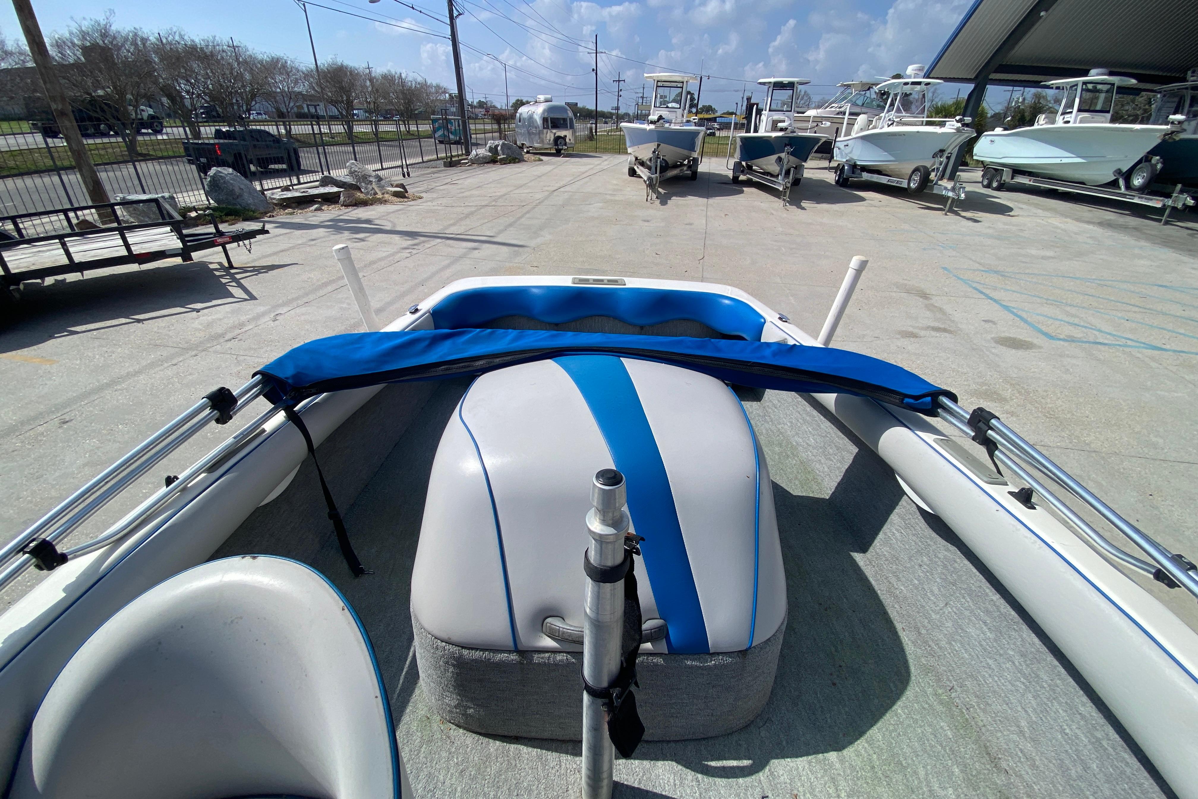 1997 Malibu Tantrum boat interior with blue and white seating, parked outdoors.