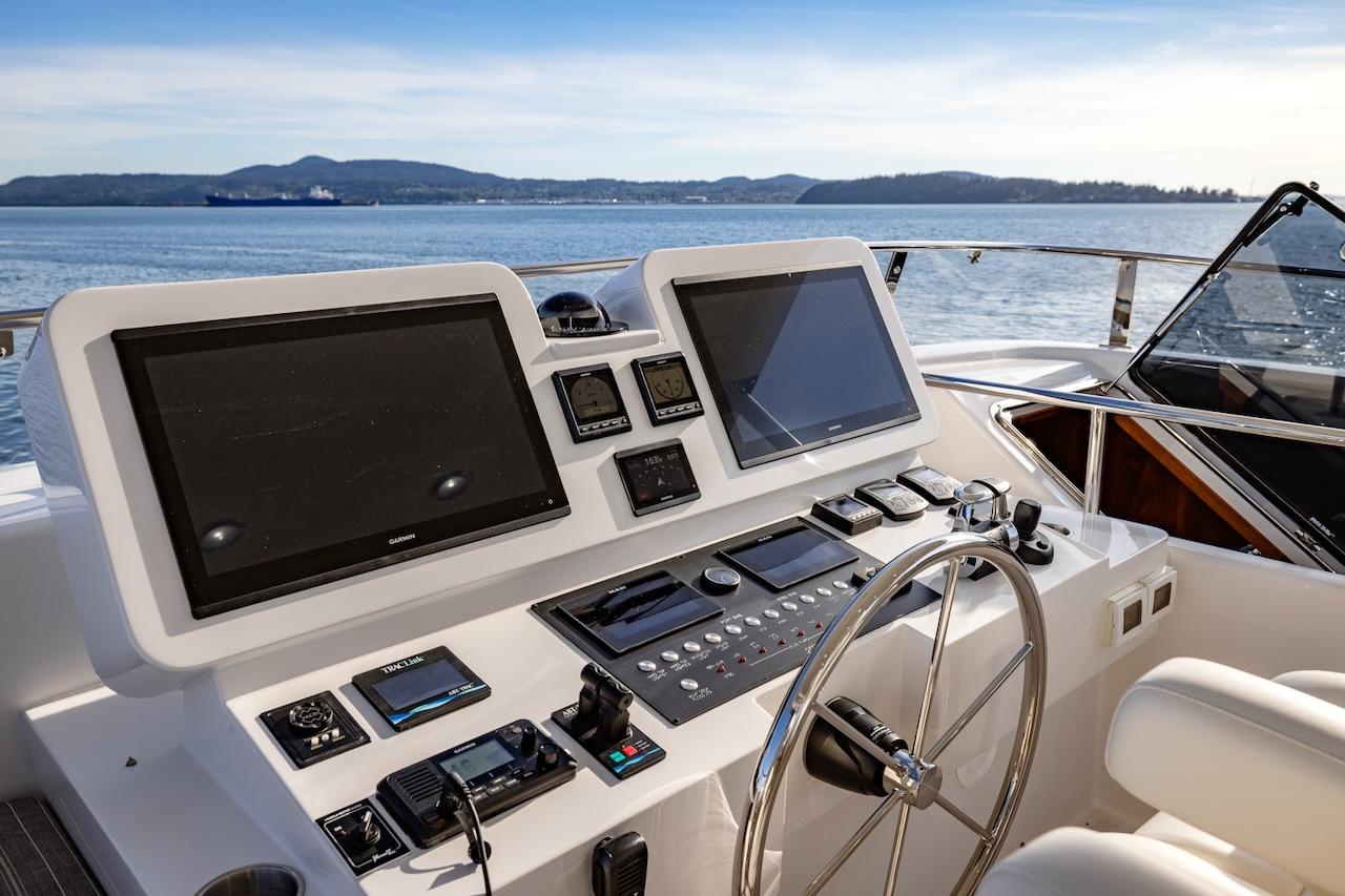 Helm of 2027 Offshore Yachts 70 CE with dual screens and navigation controls.