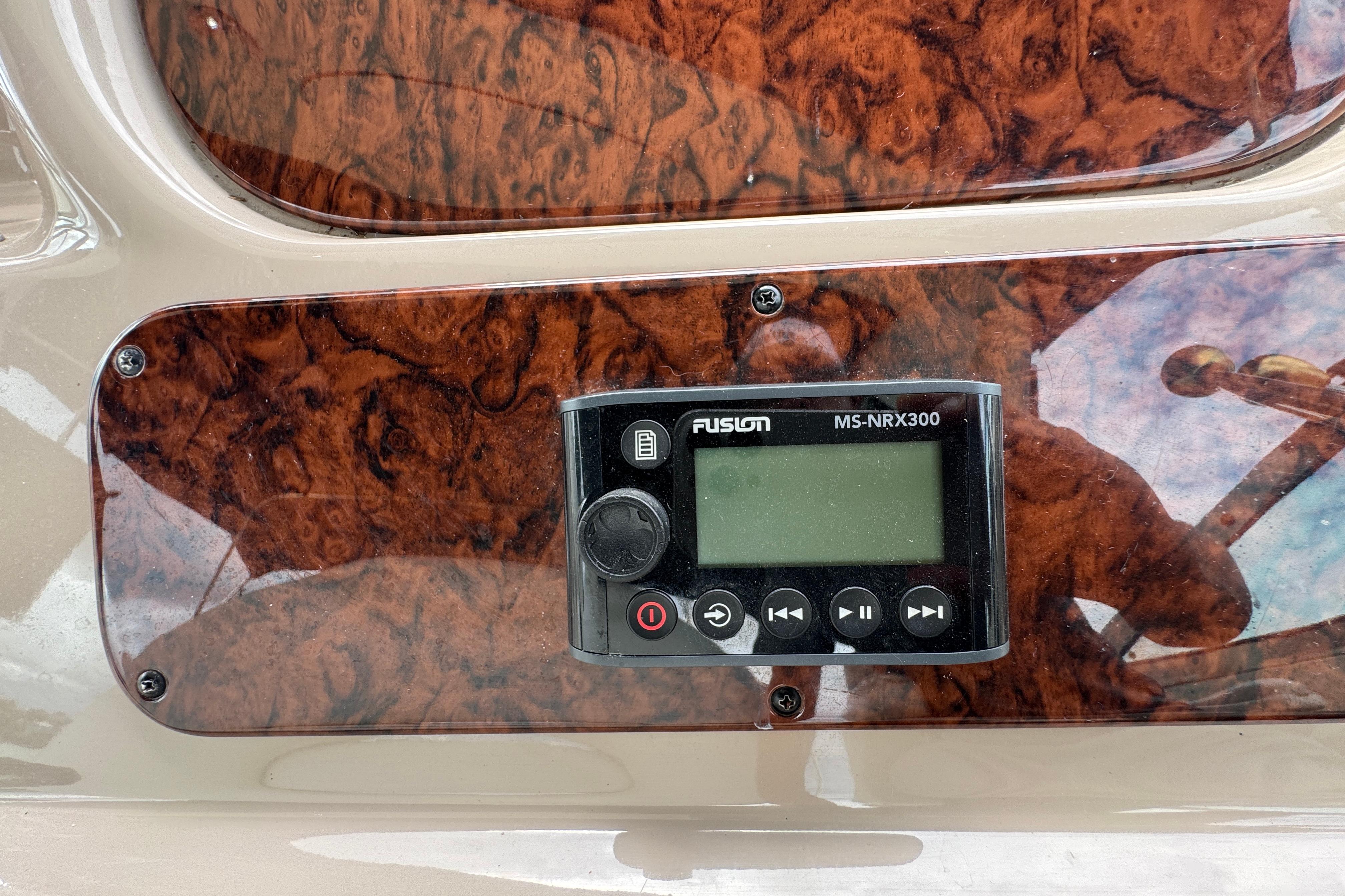 Fusion MS-NRX300 stereo on 2001 Sea Ray 380 Sundancer's woodgrain dashboard.