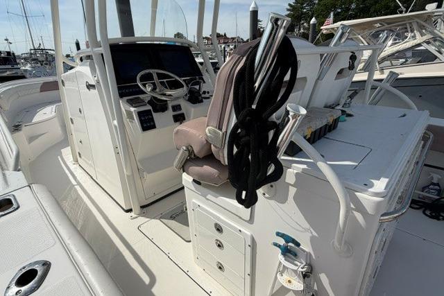 2014 Edgewater 318CC boat interior with helm, seating, and storage compartments.