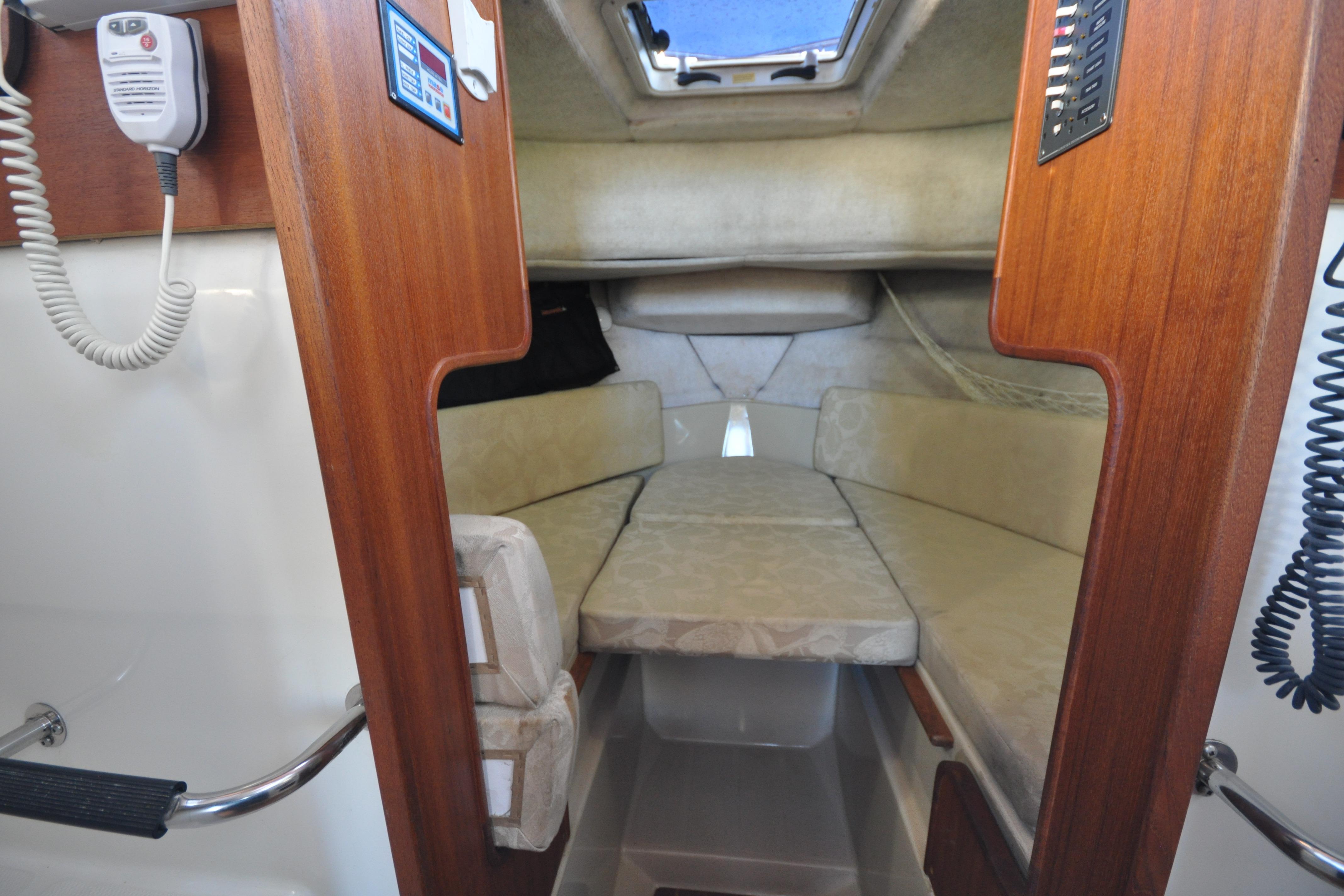 2007 Ranger Tug R-25 cabin interior with cozy seating and wooden accents.