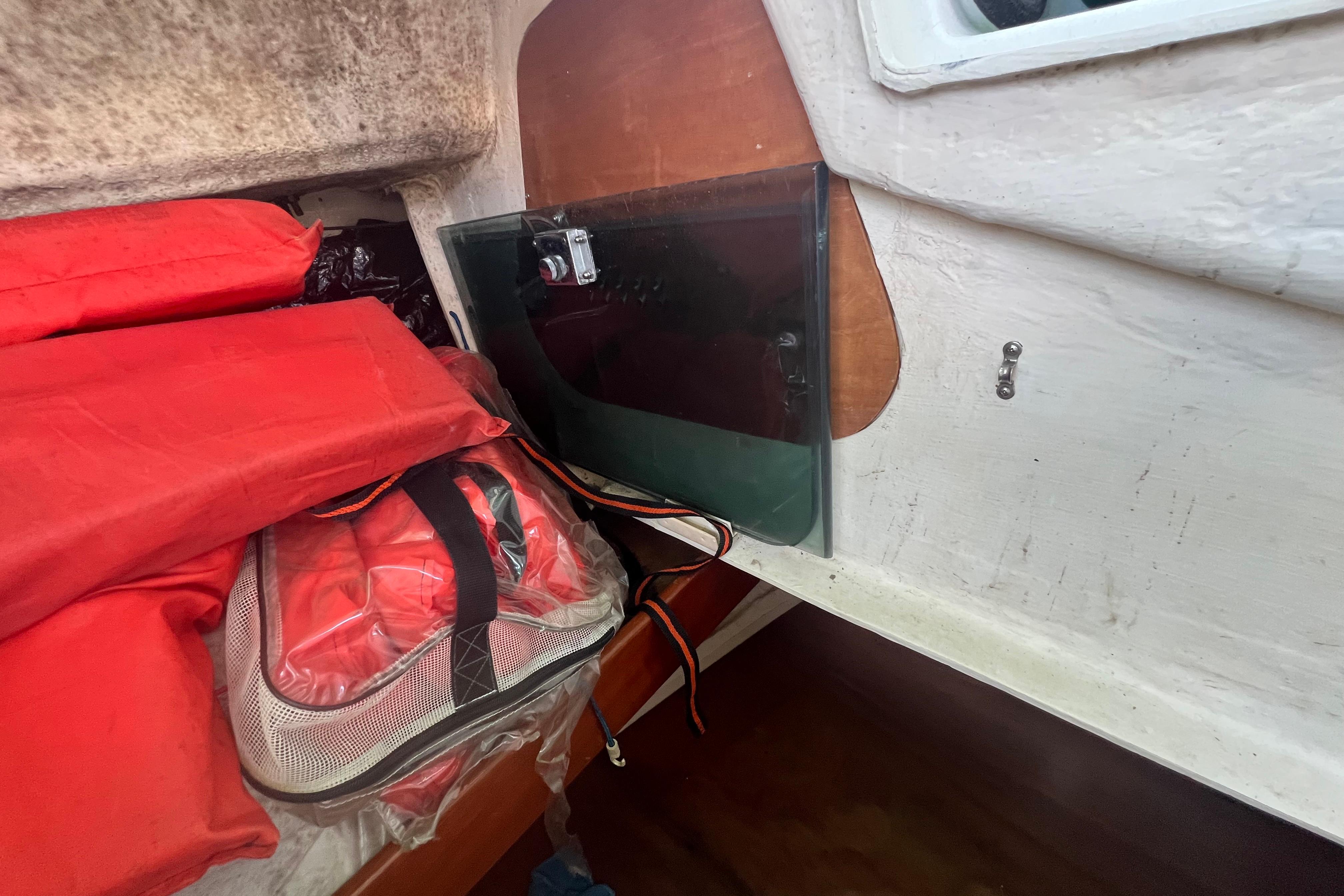 Interior of 2001 Beneteau Oceanis 473 with life jackets and storage area.