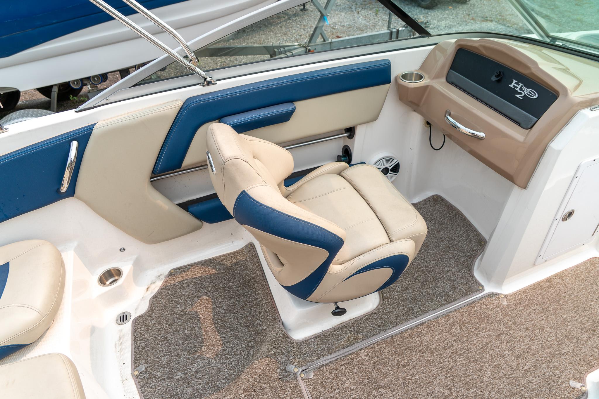 2014 Chaparral 21 Ski & Fish H2O boat interior with beige and blue seating.