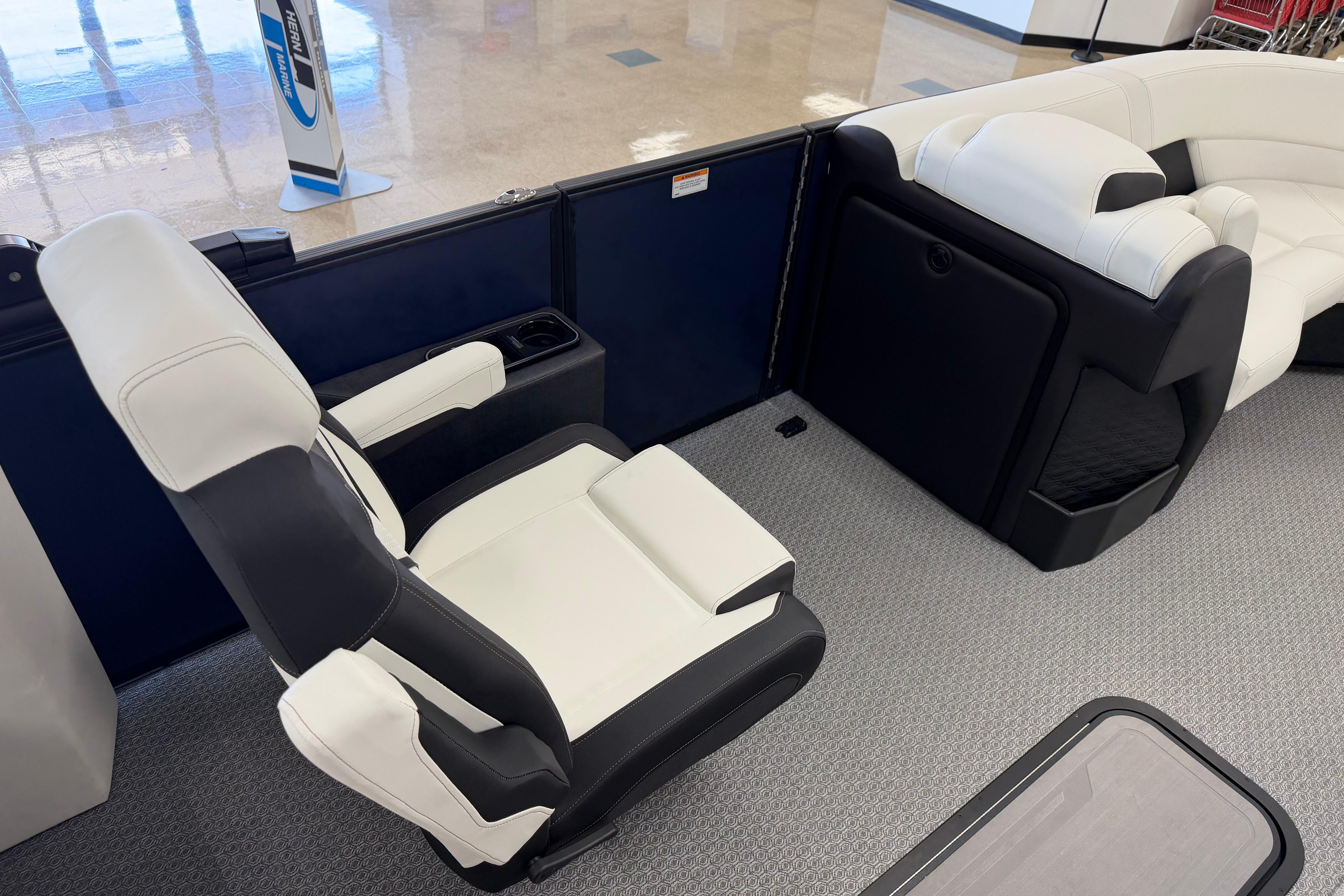 Luxurious seating in the 2026 Evotti 721CS boat, featuring sleek black and white upholstery.