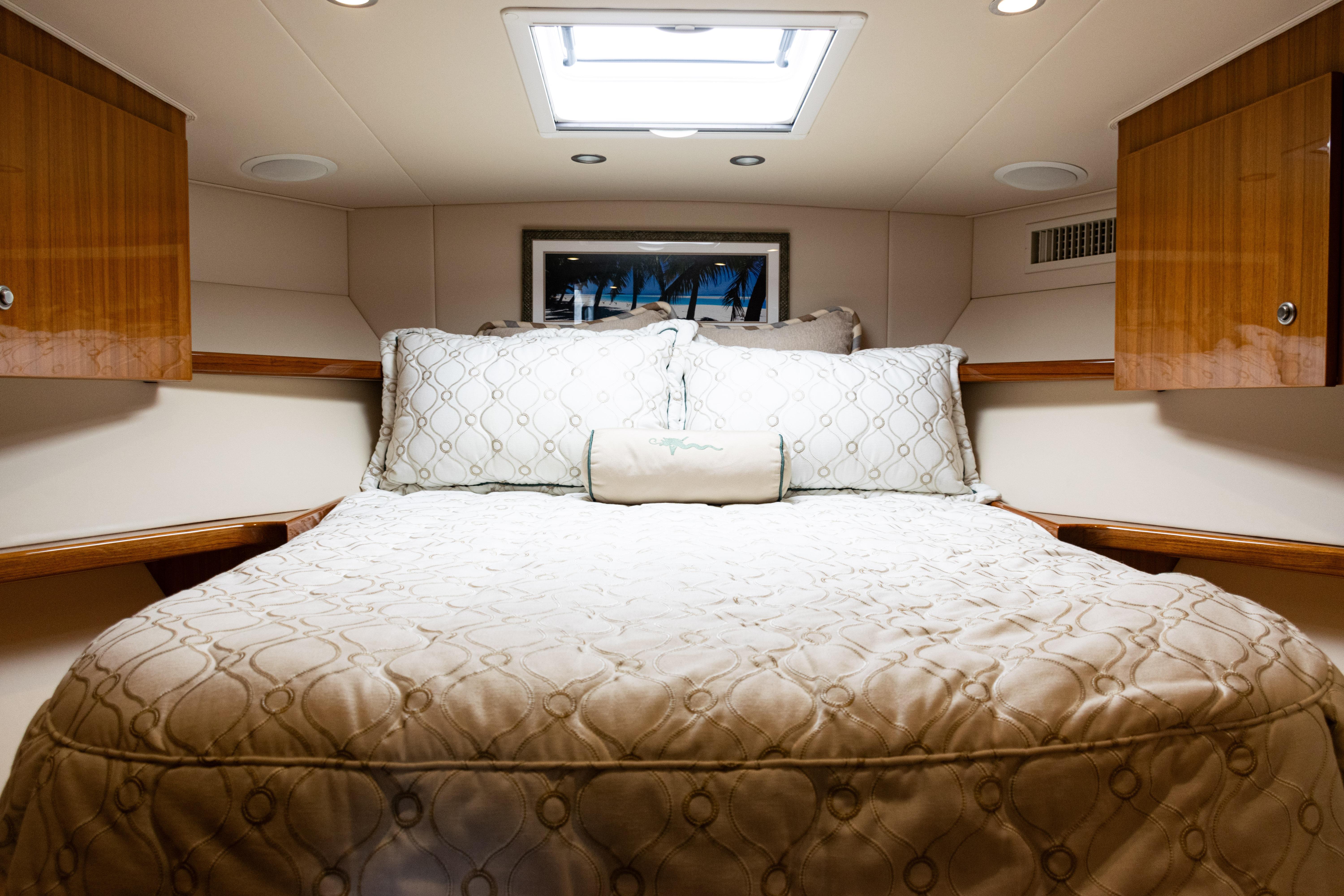 Luxurious bedroom interior of 2021 Viking 44 Open yacht with elegant bedding.