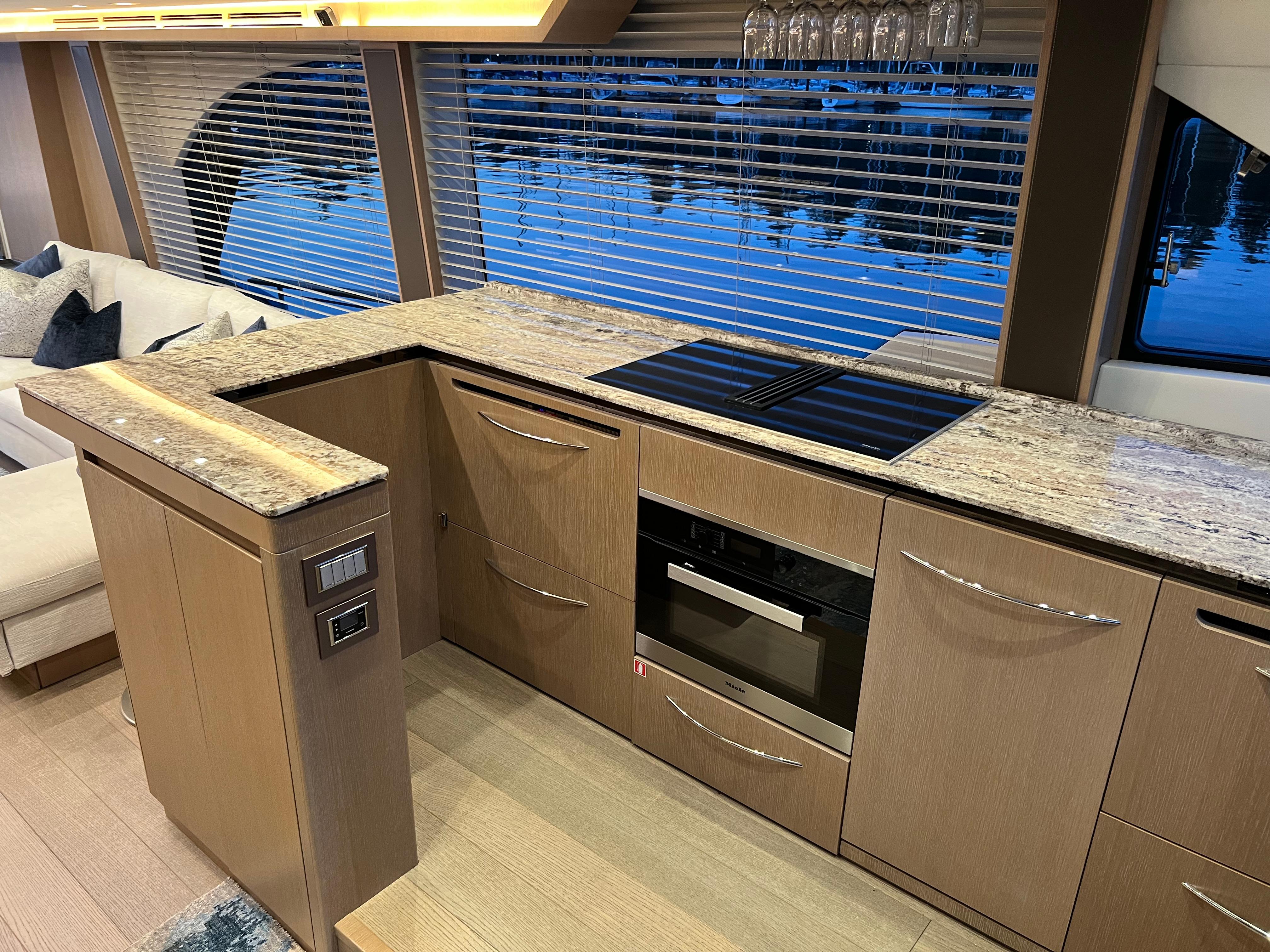 Luxurious kitchen interior of 2020 Monte Carlo Yachts MCY 70 with modern appliances and sleek design.