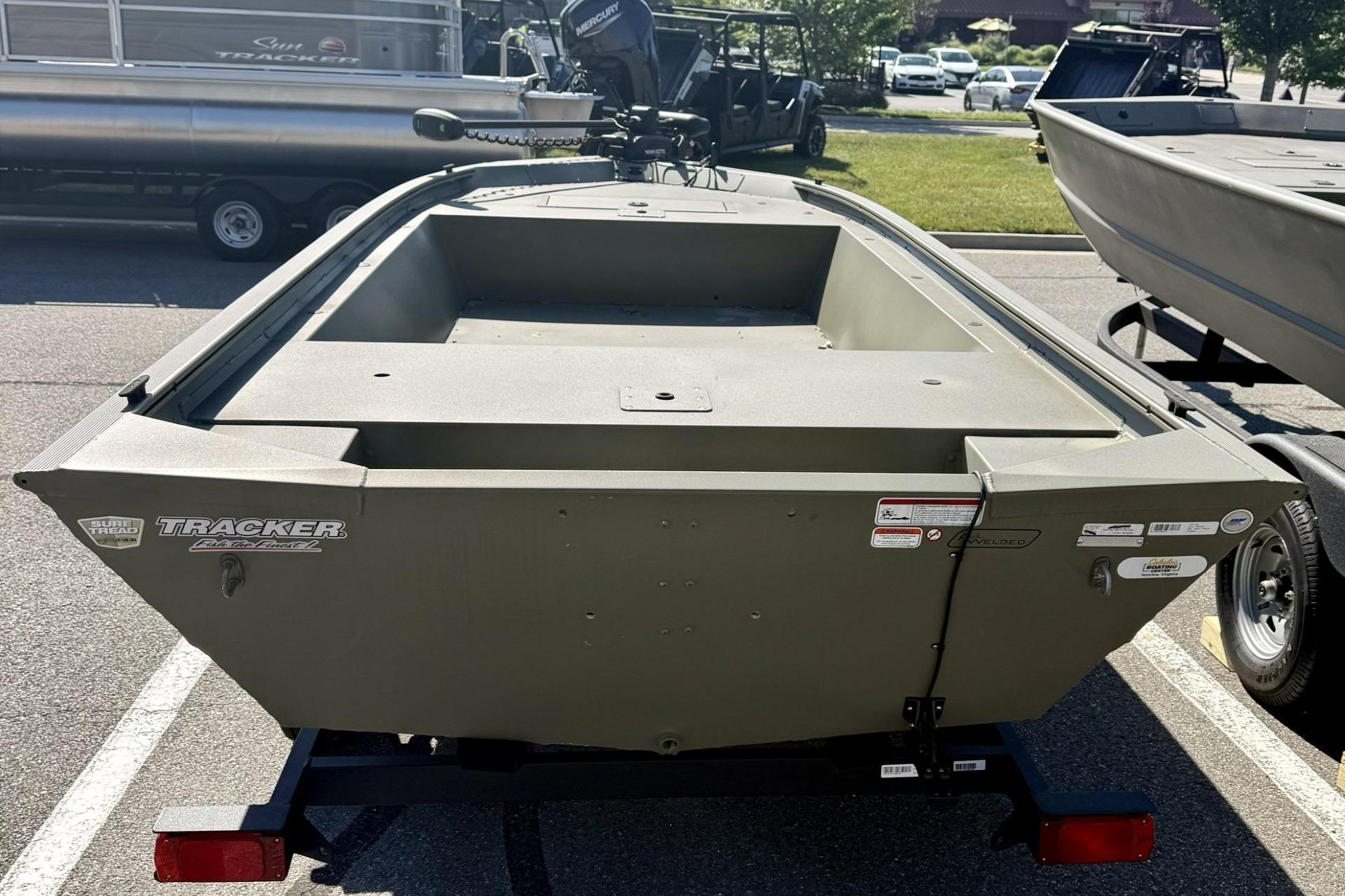 2024 Tracker Grizzly 1648 Jon boat on trailer, displayed outdoors.