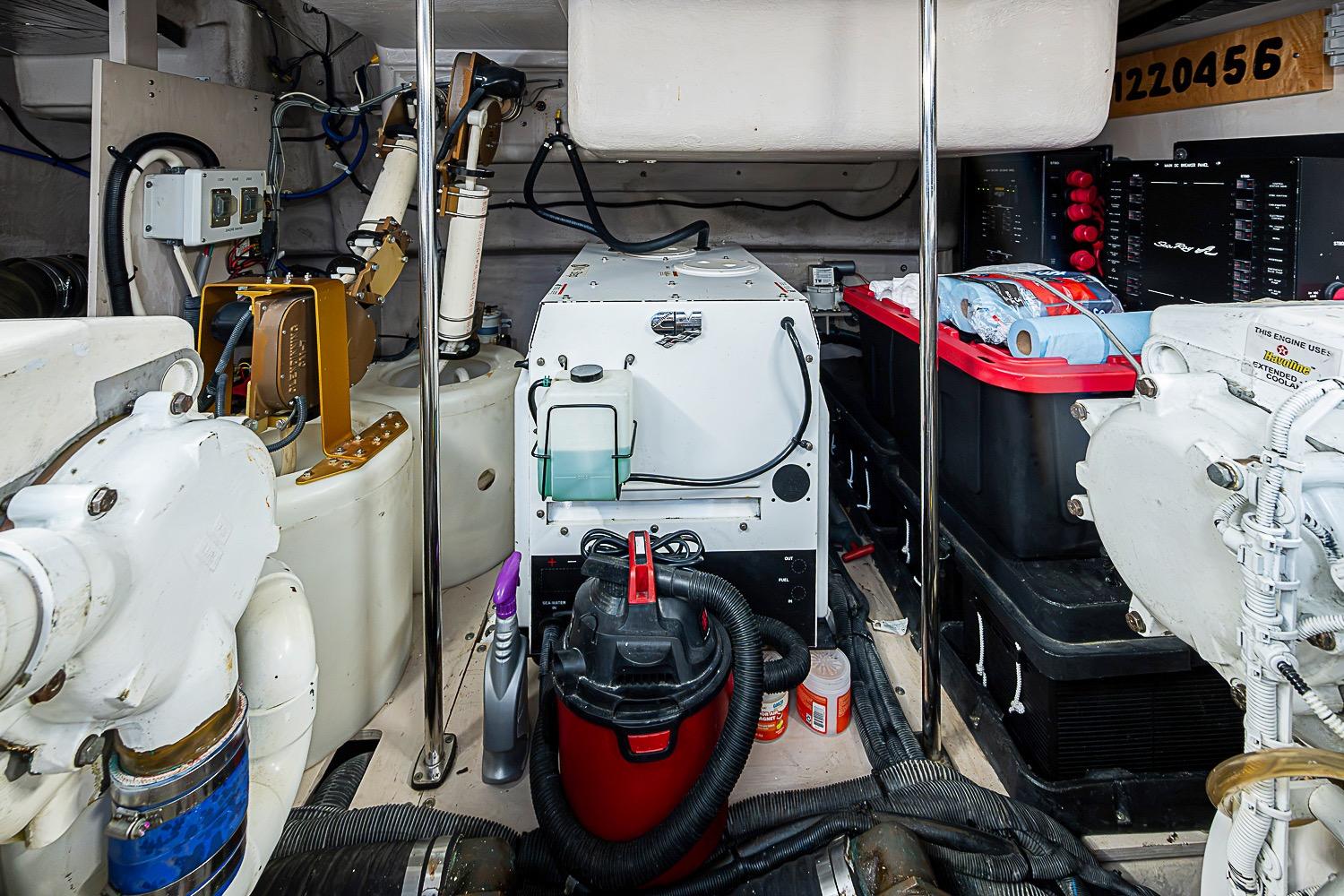 Engine room of a 2008 Sea Ray 60 Sundancer yacht, featuring mechanical equipment and storage.