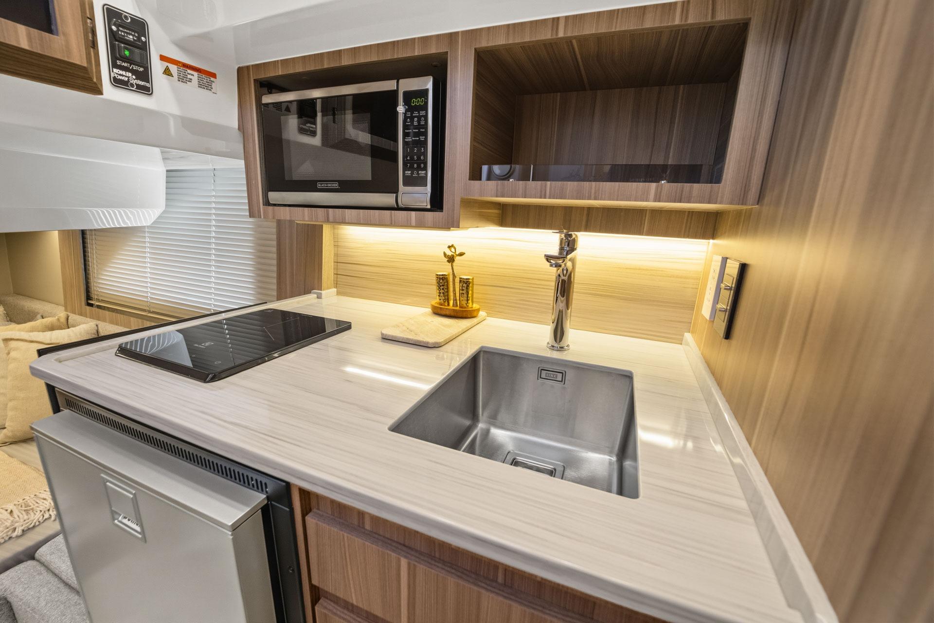 Modern RV kitchen interior with sleek appliances, Hanover 447 model, 2026.