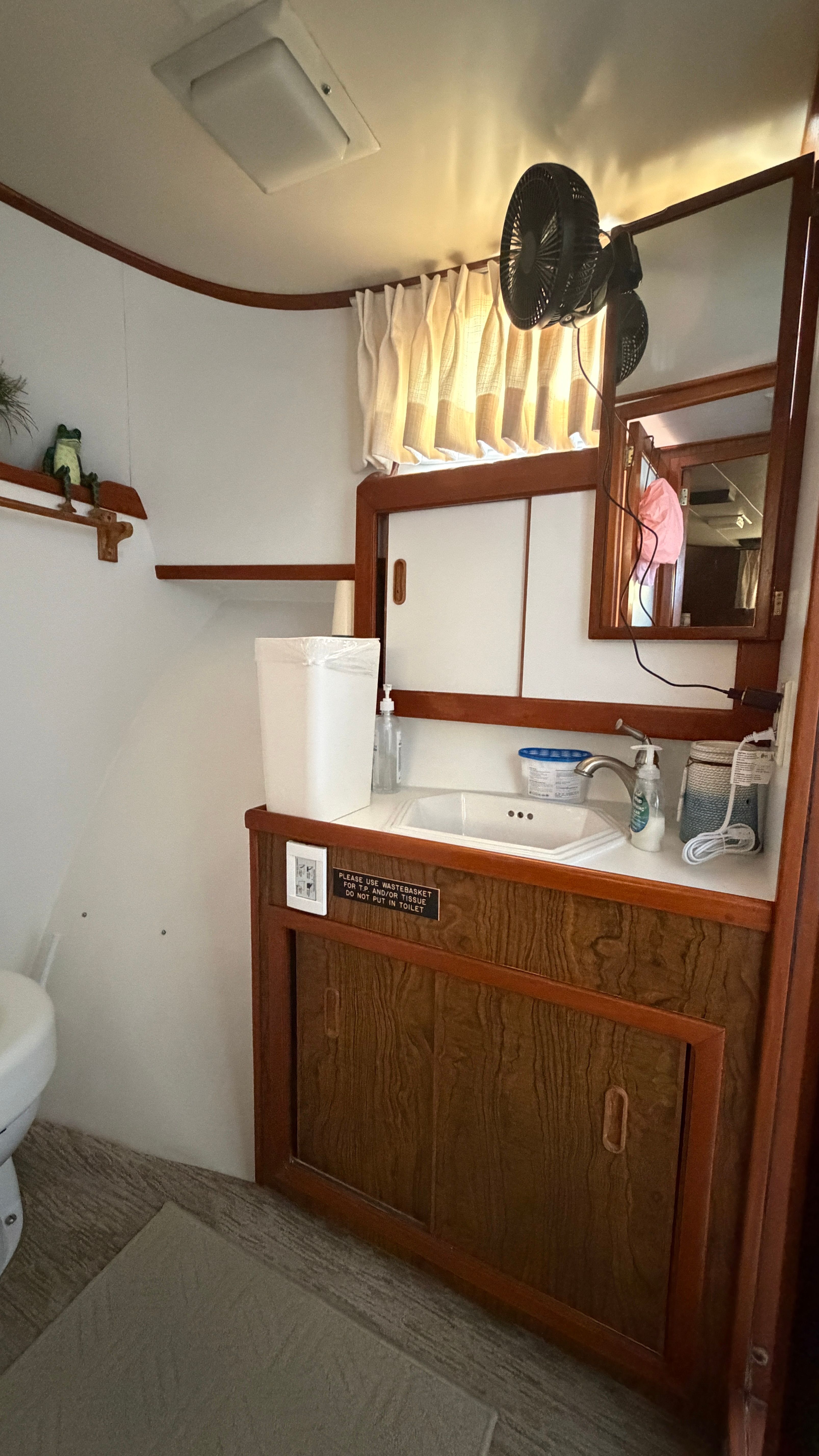 Interior of a 1966 Drake Yachtfisher with sink and mirror.