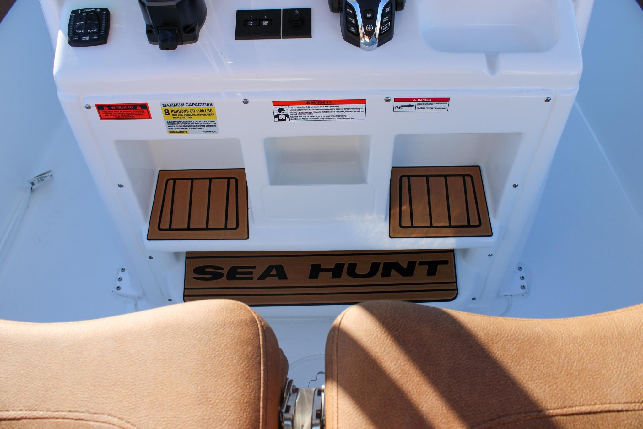 2026 Sea Hunt Gamefish 25 boat console with controls and warning labels.