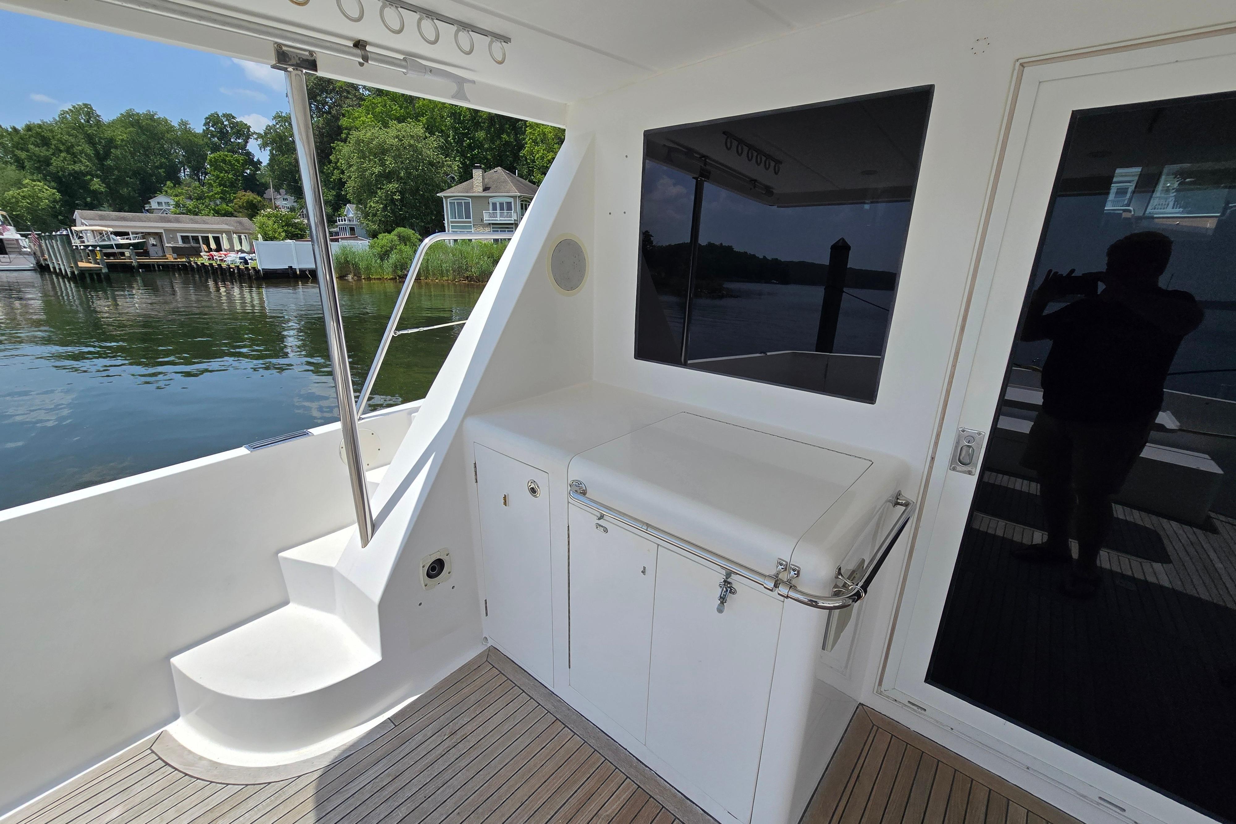 Outdoor deck of 2004 Grand Harbour 58 yacht with scenic waterfront view.