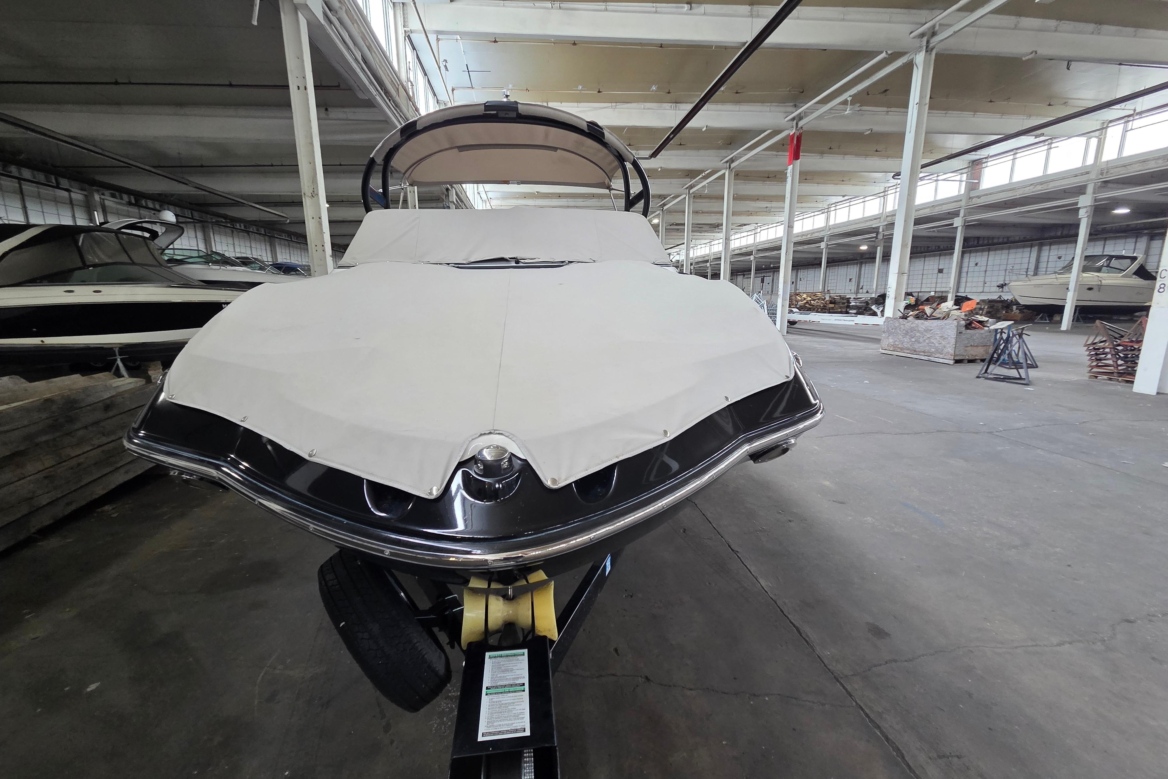 2013 Yamaha 242 Limited S boat in storage, covered and on a trailer.